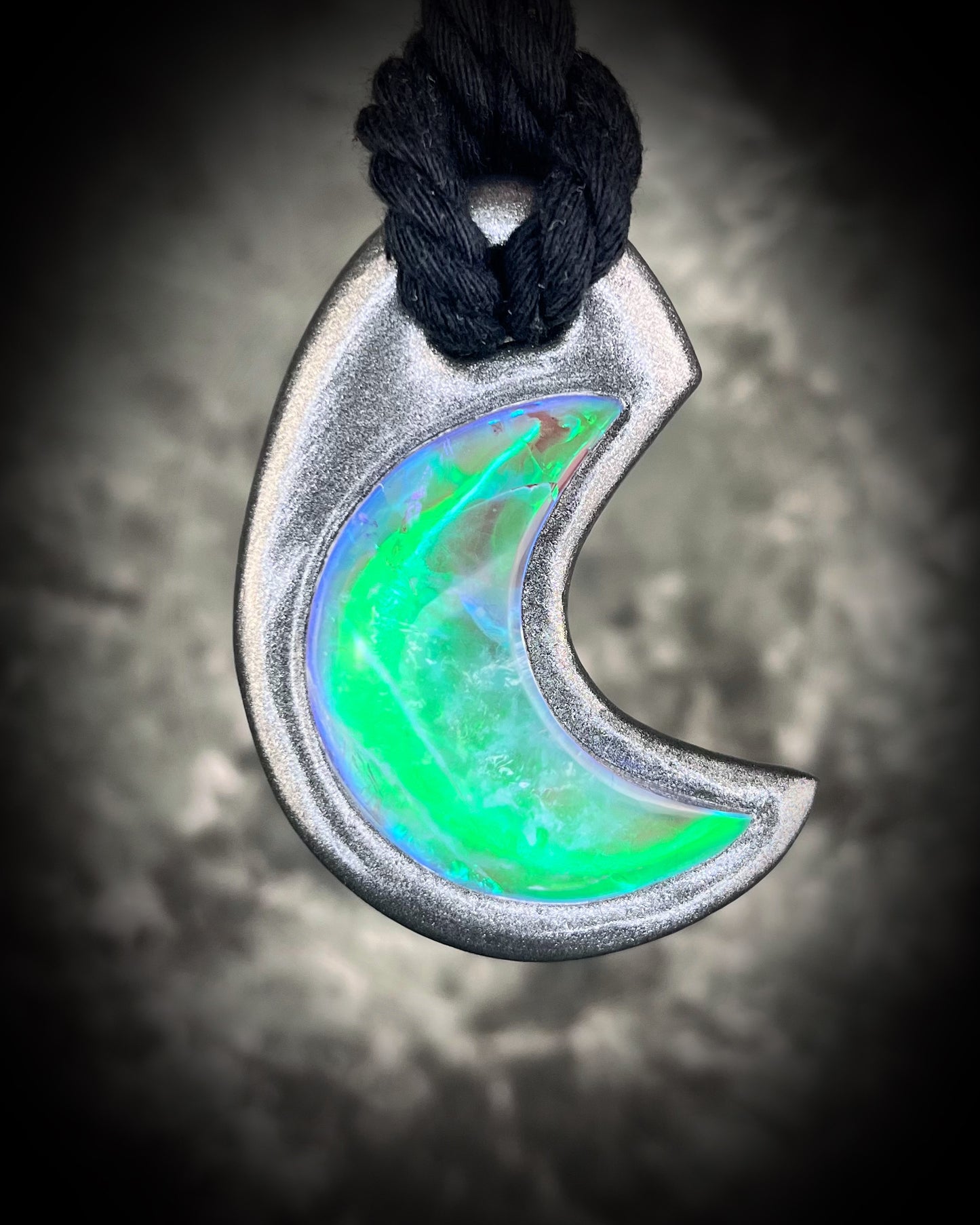 Handmade statement necklace in a crescent moon shape, genuine quartz, gemstone, crystal, in a silver finish hung from an eco-friendly and sustainable black recycled silk.