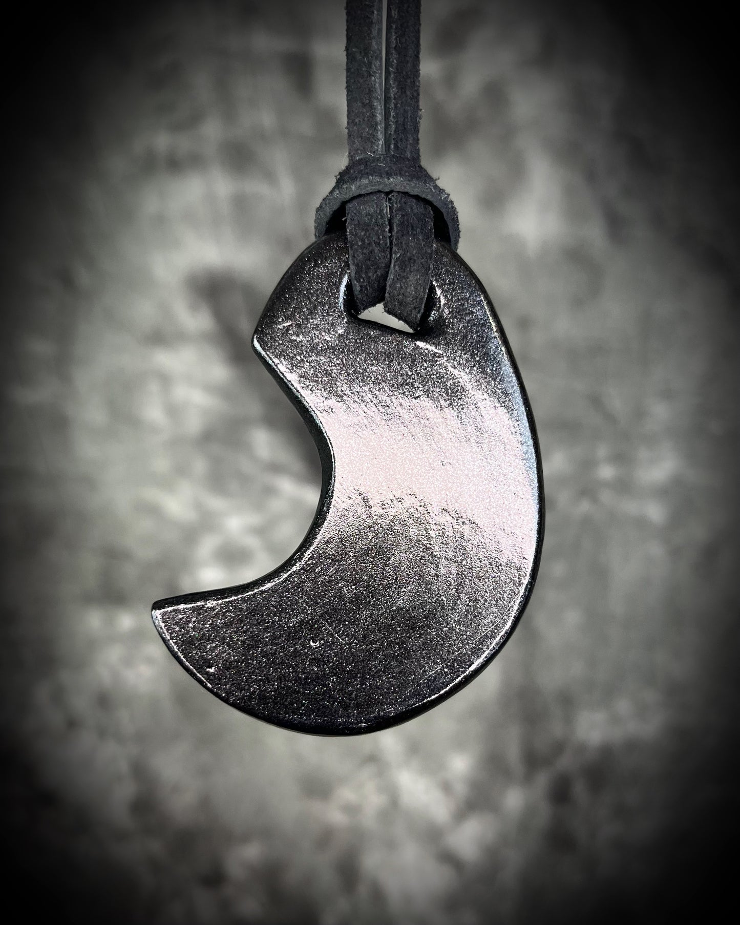 Back of David Bowie inspired glam handmade designer crescent moon necklace. Black finish on black leather. Queer, Transgender, Non-Binary jewelry!