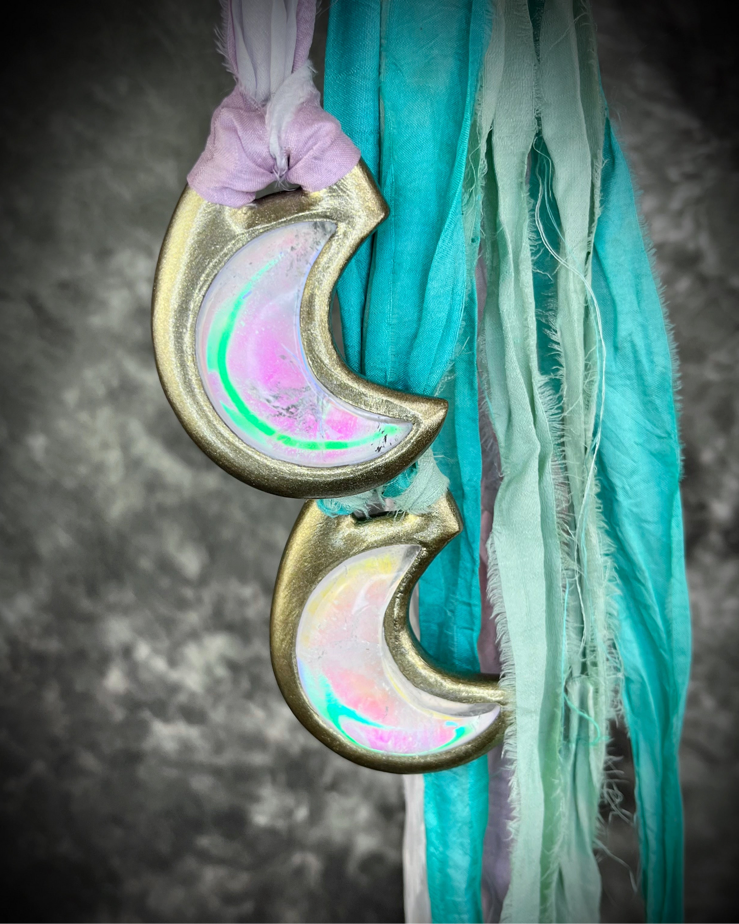 Handmade designer pink and green opalescent quartz gemstone crescent moon pendants in a gold finish. These crystal healing necklaces are strung from lilac, white, turquoise and mint green recycled silk for the sustainable bride or jewelry collector.
