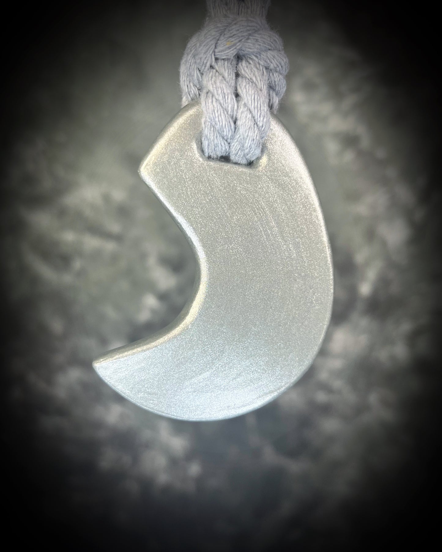 Handcrafted designer opalescent quartz gemstone crescent moon pendant in a silver finish. This crystal healing necklace is strung from a grey cotton rope for birthday or mystical tarot cocktail party.