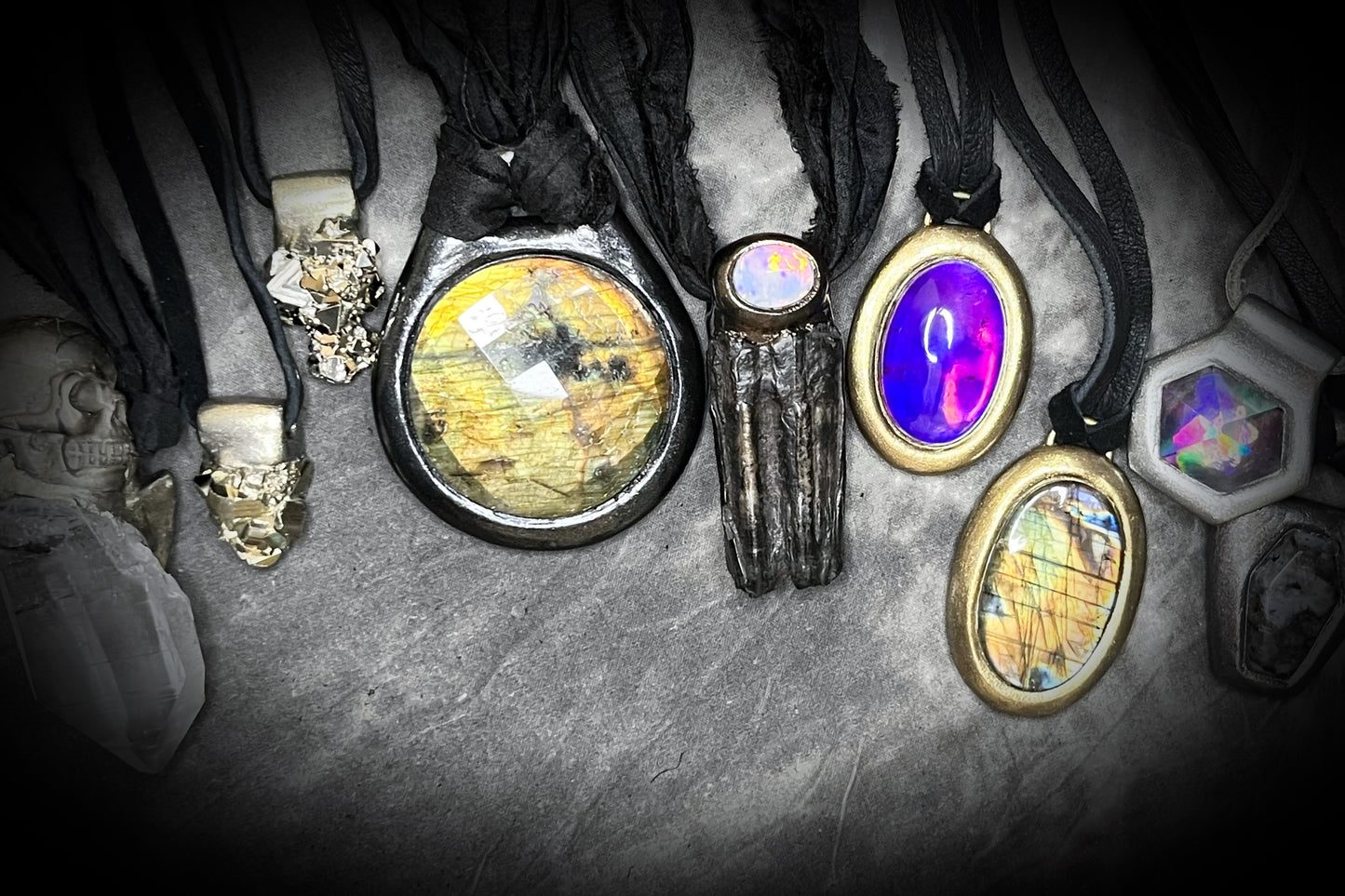 Mystical labradorite necklace on black leather cord, hand-sculpted artisan talisman with raw gemstone pendant, gothic crystal jewelry for spiritual style.