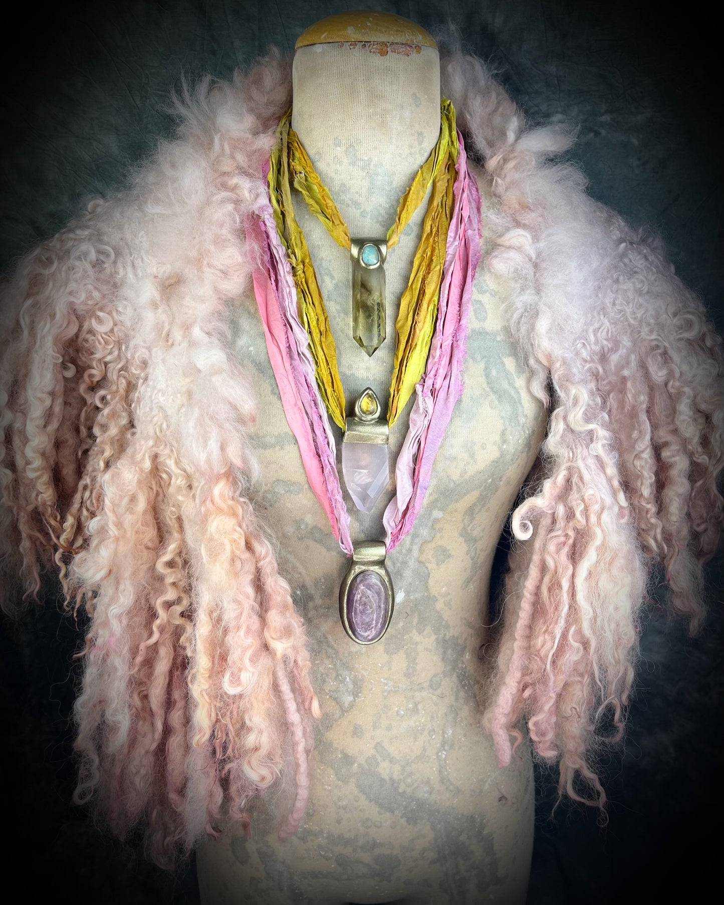 Handmade designer anti-anxiety crystal lepidolite raw stone necklace in gold finish. This gemstone pendant is hung from recycled silk for a magical and sustainable elegance.