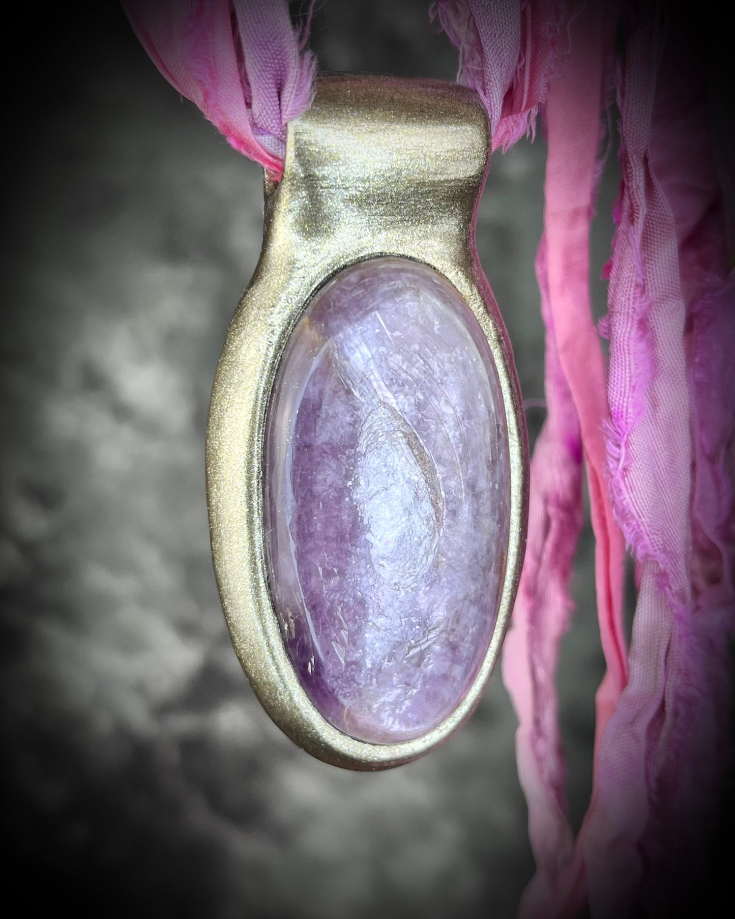 Handmade designer anti-anxiety crystal lepidolite raw stone necklace in gold finish. This gemstone pendant is hung from recycled silk, eco-friendly and perfect for festival season!