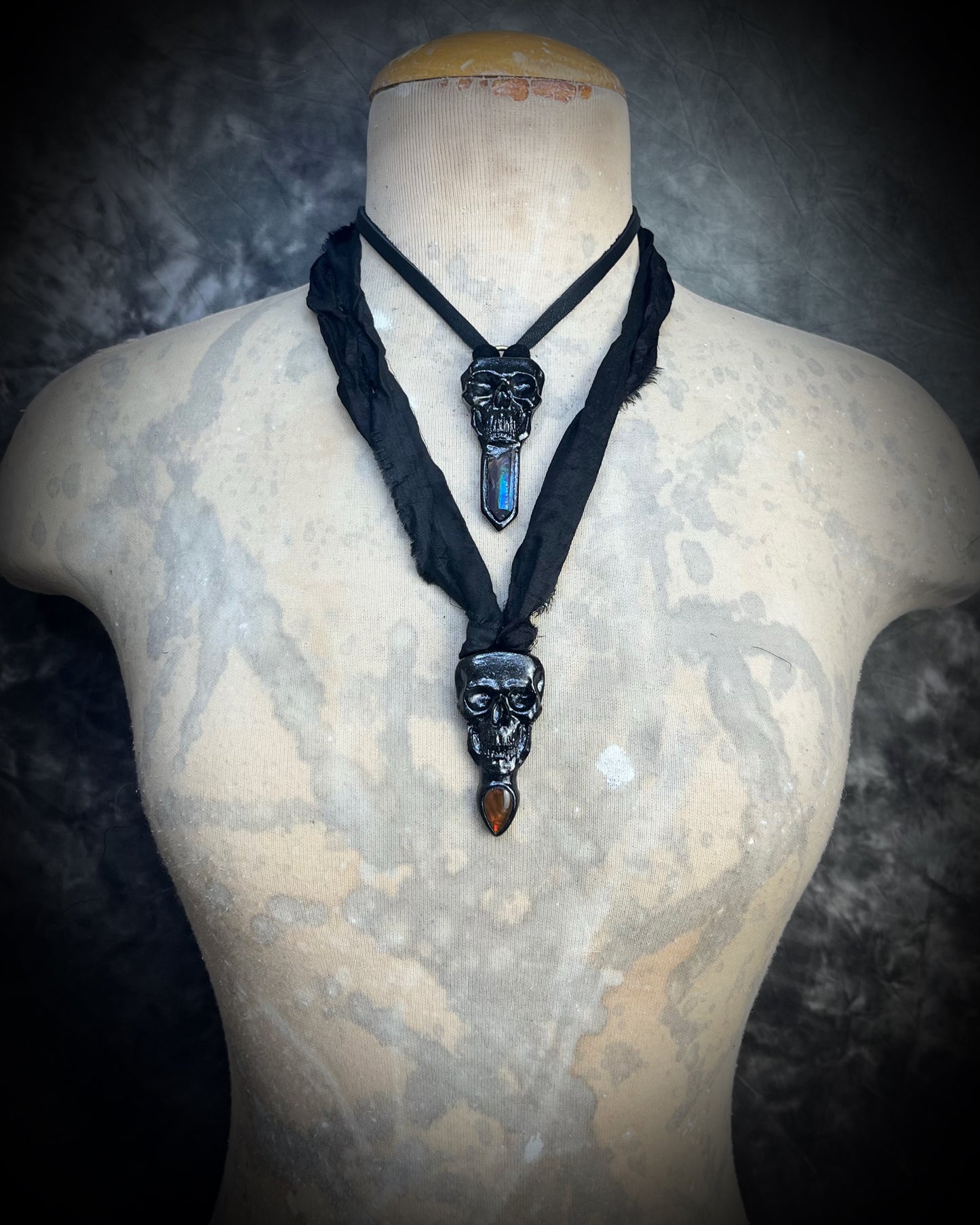 Black skull and red opalized ammolite gem necklace on black recycled silk. Macabre gothic jewelry for her, halloween gemstone jewelry for fall 2025 gift for him.