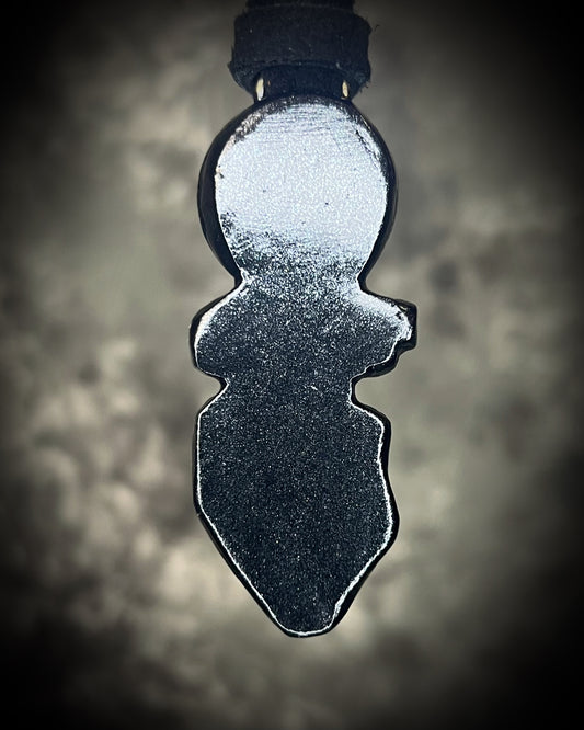 Black tourmaline and Libyan Desert Glass talisman with a man-made eye detail in a sculptural black-finish setting on black leather, handmade by Become Spellbound in Baltimore, Maryland.