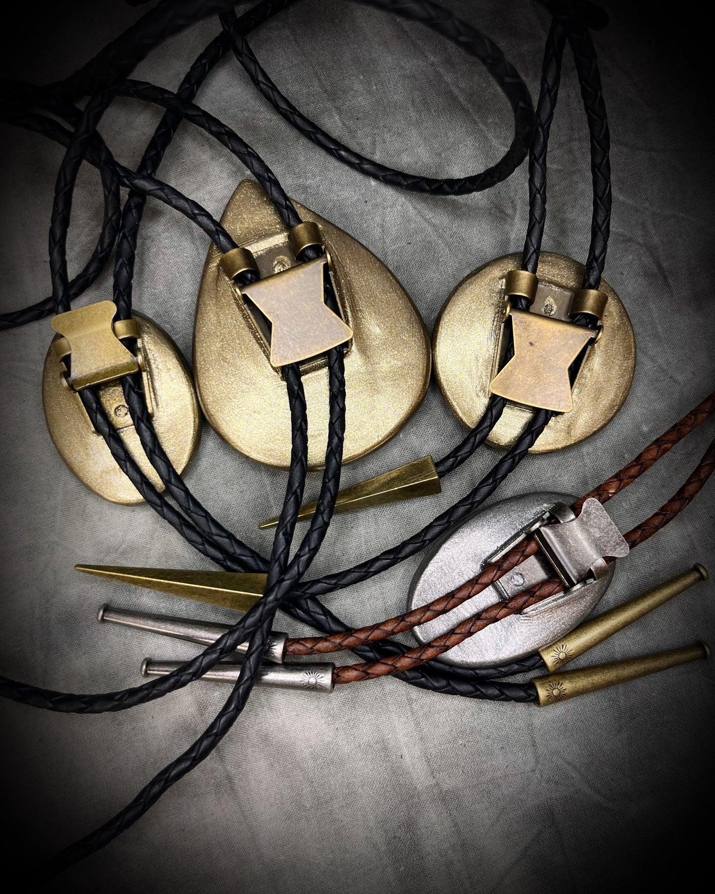 Blue Labradorite Bolo Tie in a Gold Finish with Brass Spike Tips and black leather. Statement Bolo Tie with Labradorite, Western and Witchy Bolo Tie Talisman. Back side and clasp view.