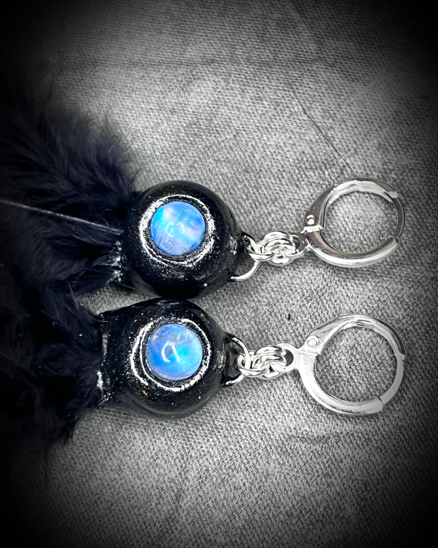 Mystical handmade black crystal earrings for her. Handmade ib the USA black feather and moonstone dangle earrings on sterling silver hooks.