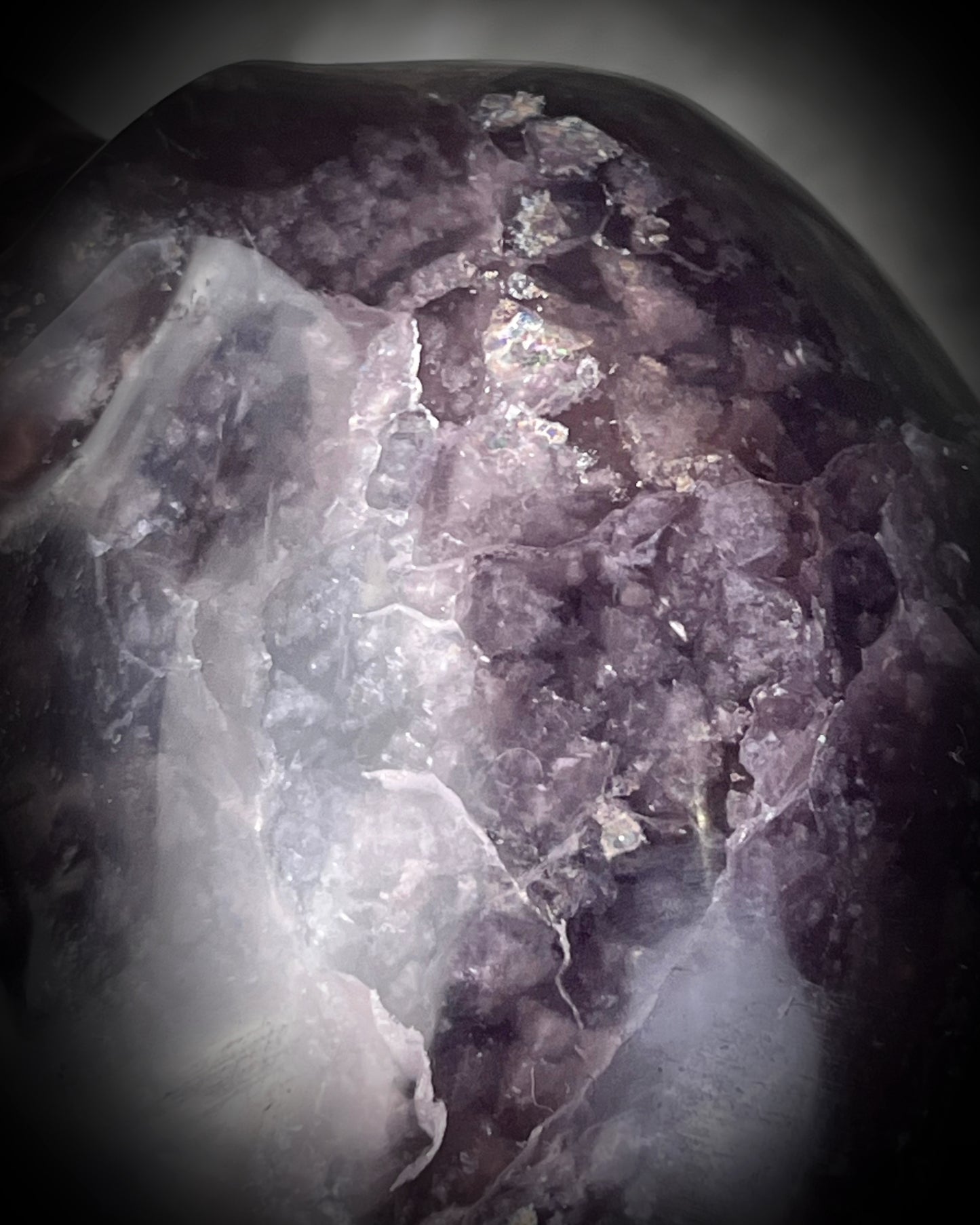 Closeup of Purple Fluorite Crystal skull with shimmer and rainbows. 5" extra large crystal skull for gifting, manifestation and magic.