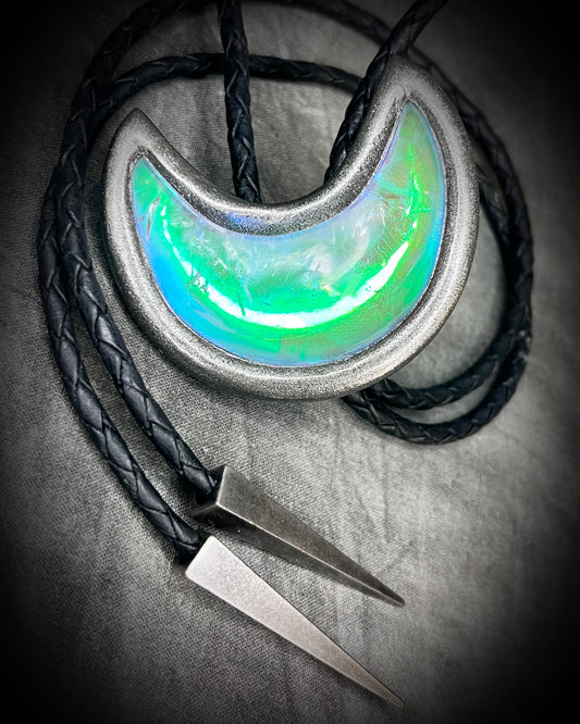 Crescent moon crystal bolo tie with green opal quartz in gunmetal finish and spike bolo tips- designed for intuitive, lunar-inspired jewelry styling.