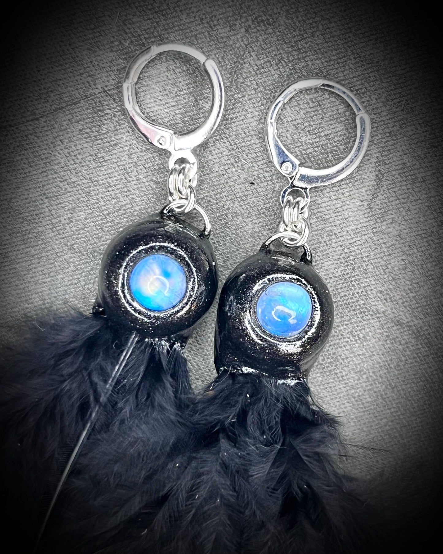 Mystical handmade black crystal earrings for her. Handmade black feather and moonstone dangle earrings on sterling silver hooks.