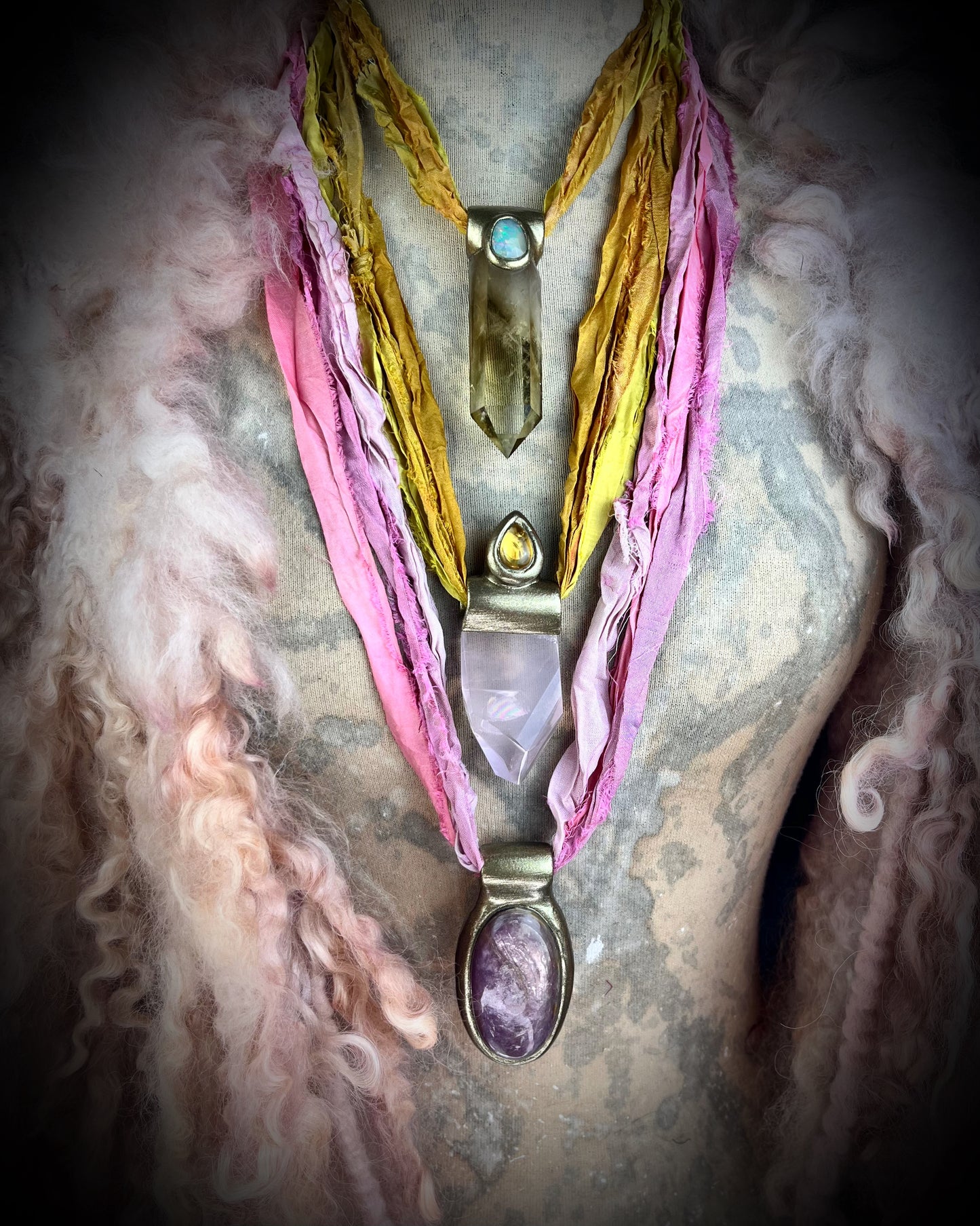 Handmade designer anti-anxiety crystal lepidolite raw stone necklace in gold finish. This gemstone pendant is hung from recycled silk for a vibrant summer and sustainable elegance.