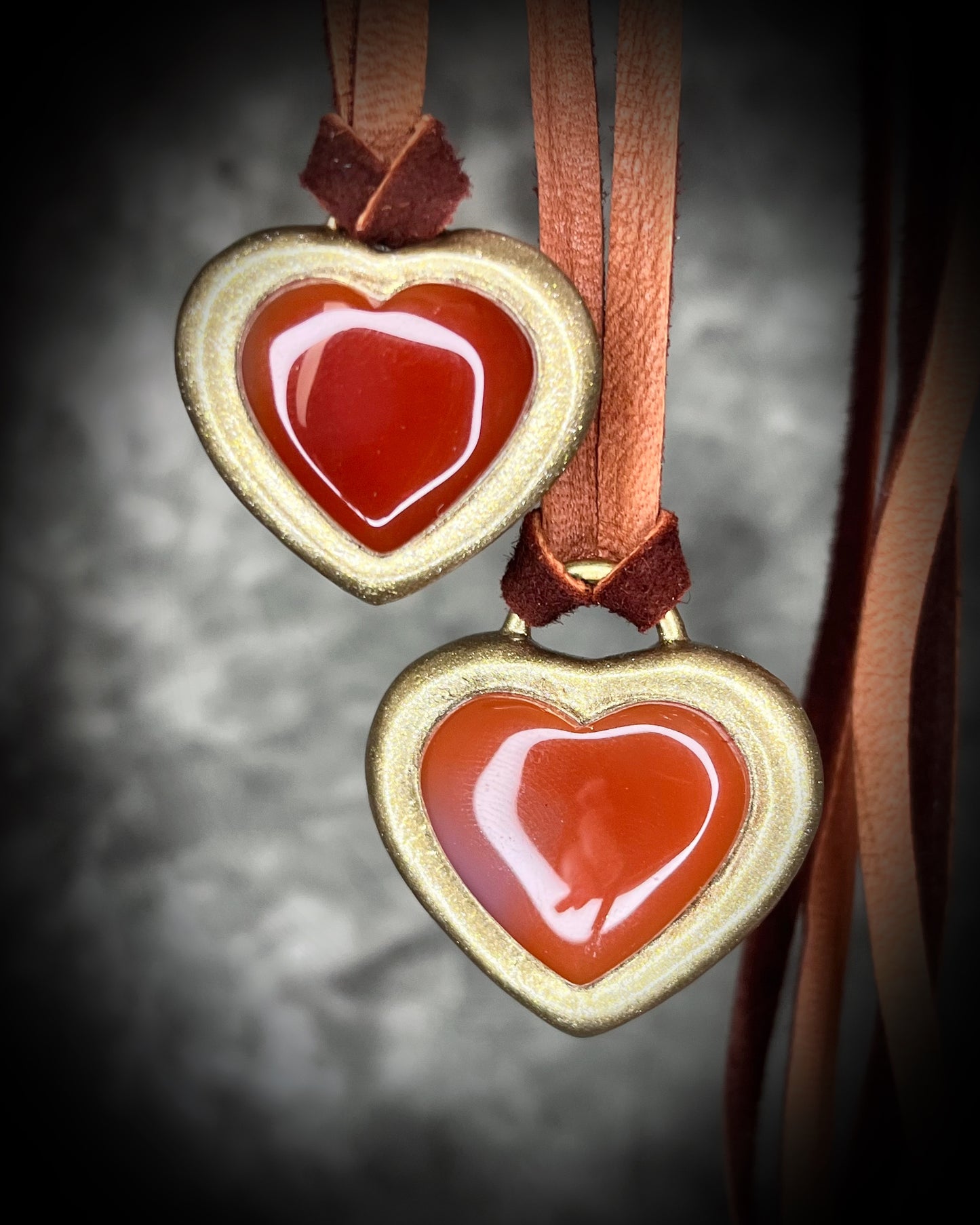 Handmade Carnelian crystal heart necklace on earthy brown leather cord, bold fall jewelry with warm orange gemstone, grounding and energizing boho style talisman.
