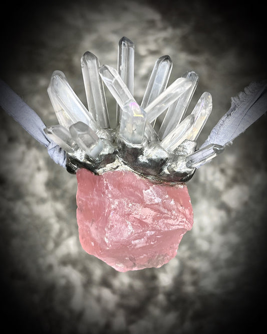 Handmade Rose Quartz talisman crowned with a quartz point crystal design, evoking the quiet authority of a queen who leads from the heart. Hung fro recycled grey silk with a silver finish, perfect for fantasy photoshoots, bridal jewelry or an impressive valentines day gift for her!