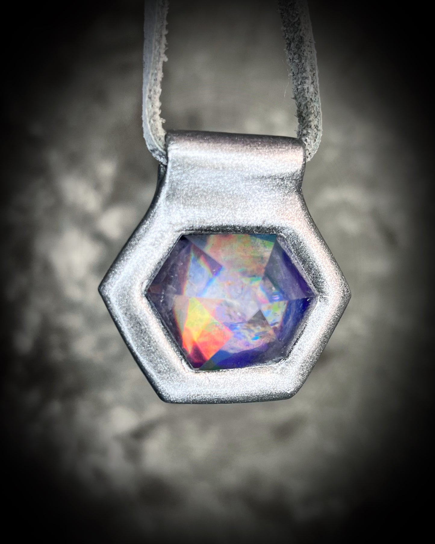 Iridescent aura black rainbow quartz crystal pendant in silver hanging from grey leather, chunky gemstone jewelry gift for her. David Bowie inspired jewelry.