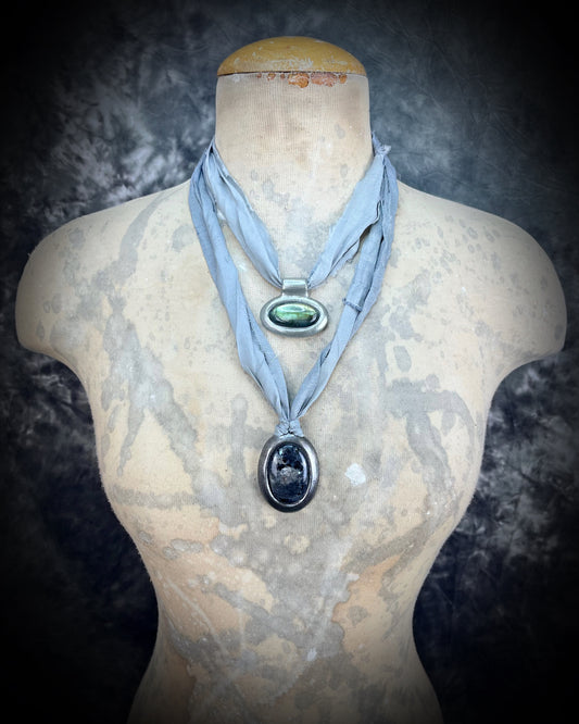 Mannequin wearing green labradorite crystal healing talisman hung from soft grey recycled silk. Gift intuition, transformation and self-love.