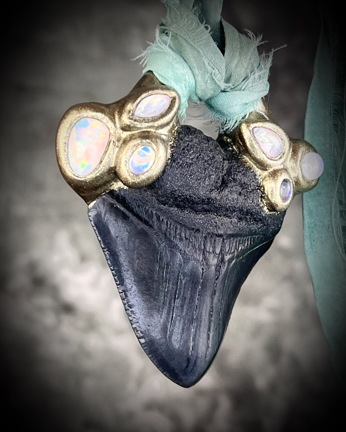 Megalodon shark tooth fossil handcrafted crystal talisman featuring opal gemstone and rainbow moonstones in gold, hung from recycled aqua silk. Beach wedding or summer jewelry photoshoot, cosplay, fantasy film costume or everyday enchantment!