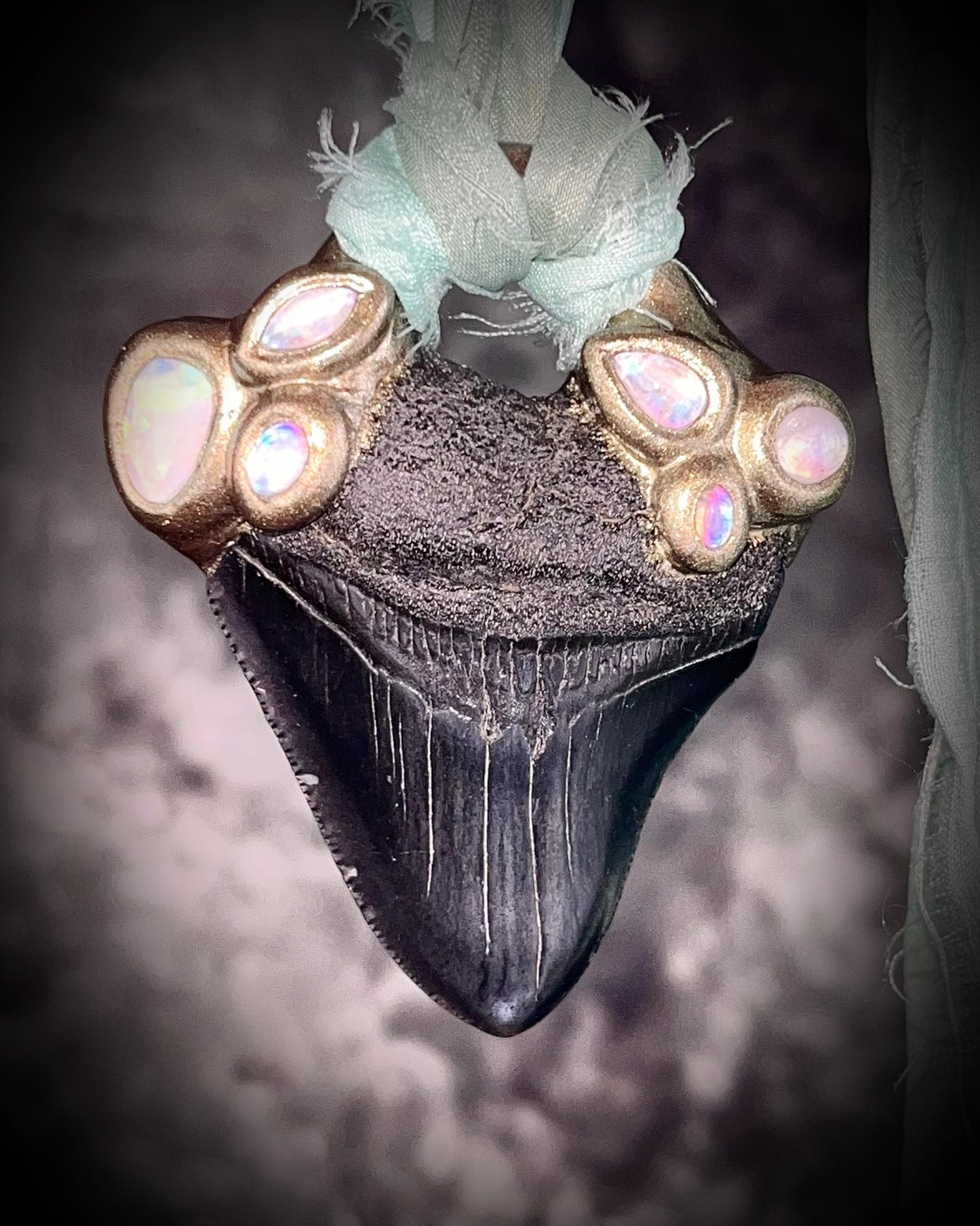 Megalodon shark tooth fossil handcrafted crystal talisman featuring opal gemstone and rainbow moonstones in gold, hung from recycled aqua silk. Beach wedding or summer jewelry photoshoot, cosplay, fantasy film costume or everyday enchantment!