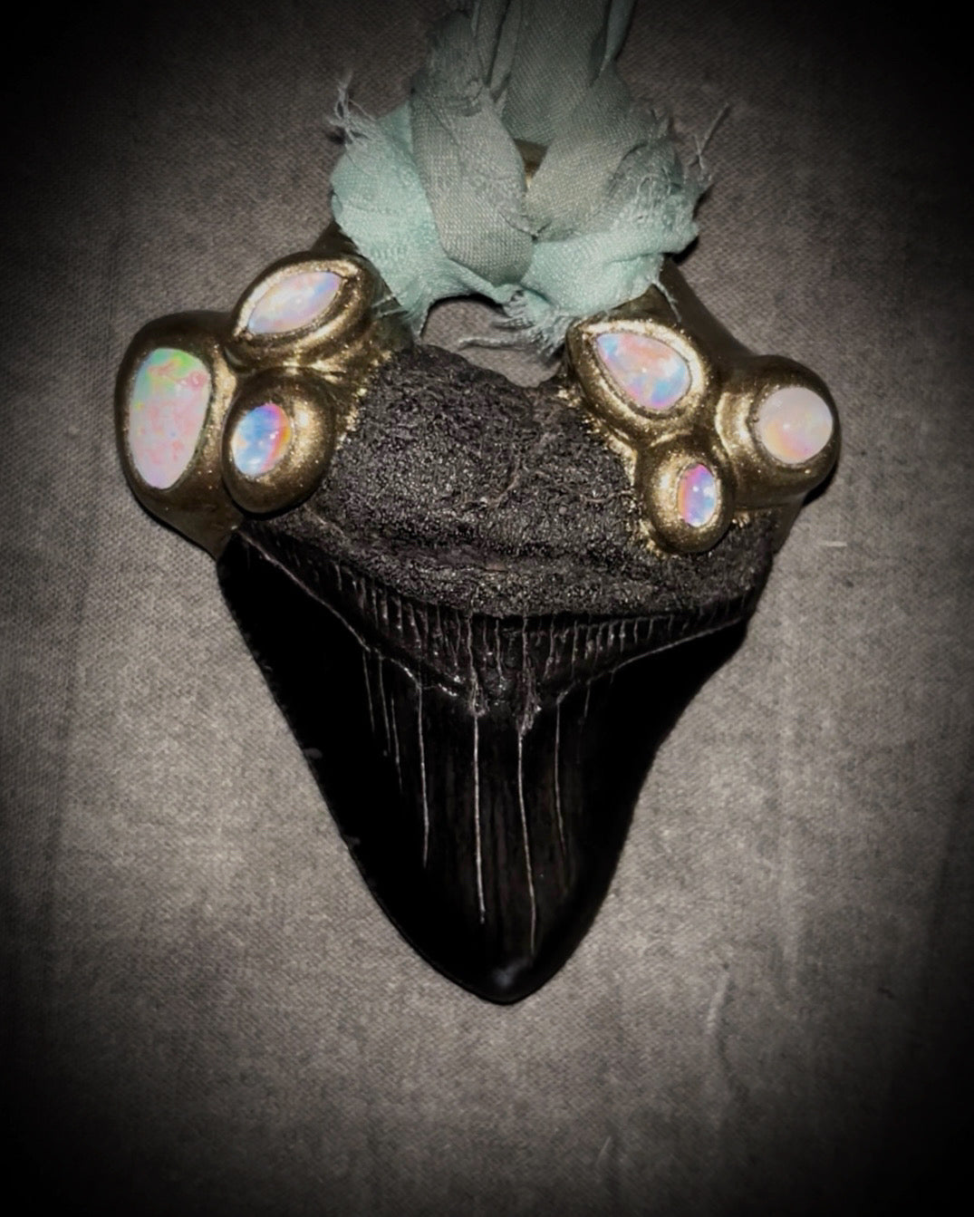 Megalodon shark tooth fossil handcrafted crystal talisman featuring opal gemstone and rainbow moonstones in gold, hung from recycled aqua silk. Beach wedding or summer jewelry photoshoot, cosplay, fantasy film costume or everyday enchantment!