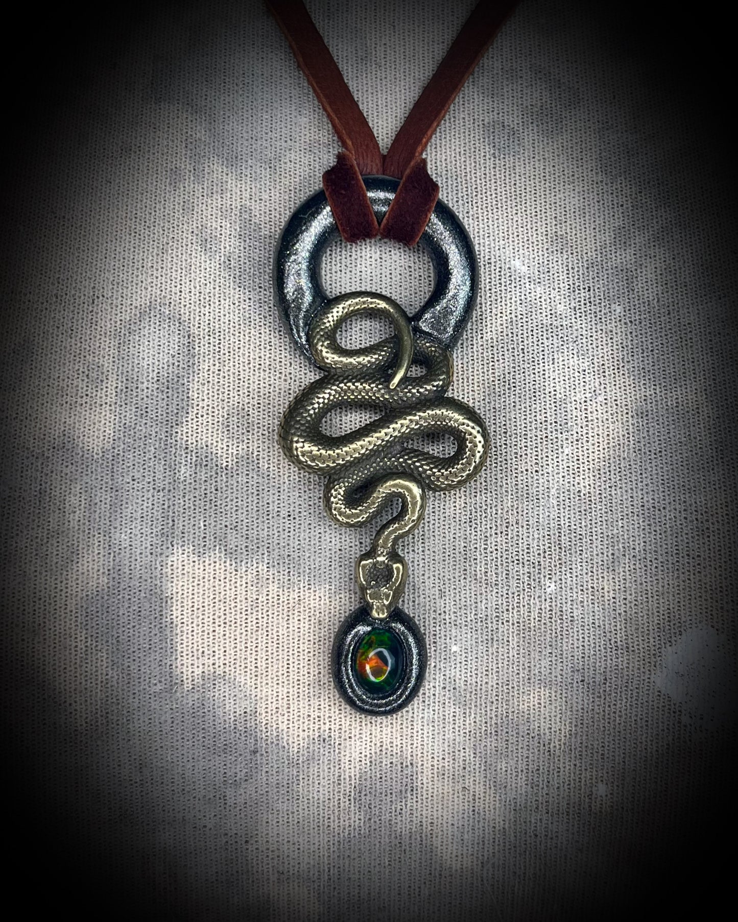 Mystical black opal and brass snake necklace, witchy jewelry with protective energy, handcrafted gemstone talisman for intuition and transformation.