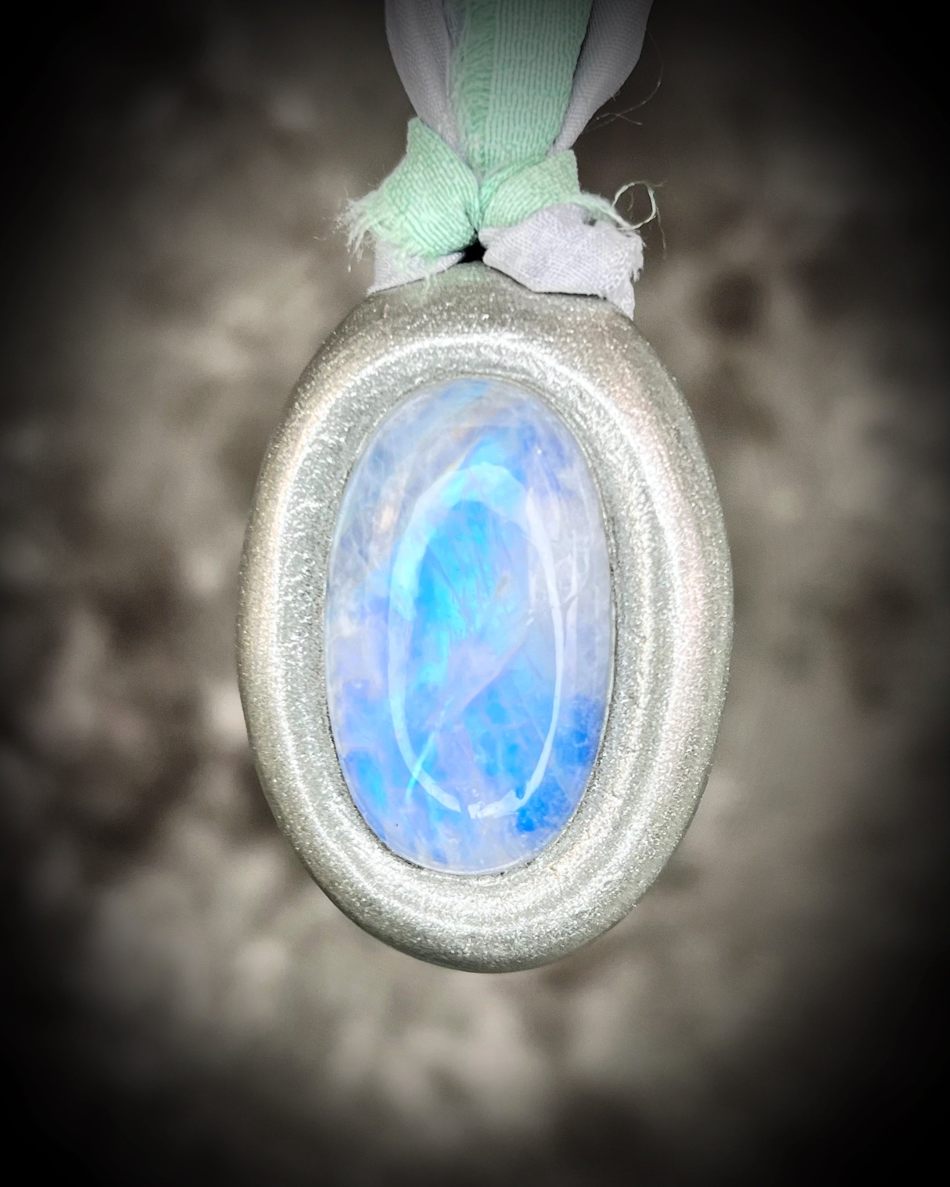 Mystical moonstone oval pendant in silver tone setting on recycled silk cord. Handmade crystal necklace for intuition, divine feminine energy, and spiritual connection. Unique gift for her, gemstone jewelry for meditation or daily wear.
