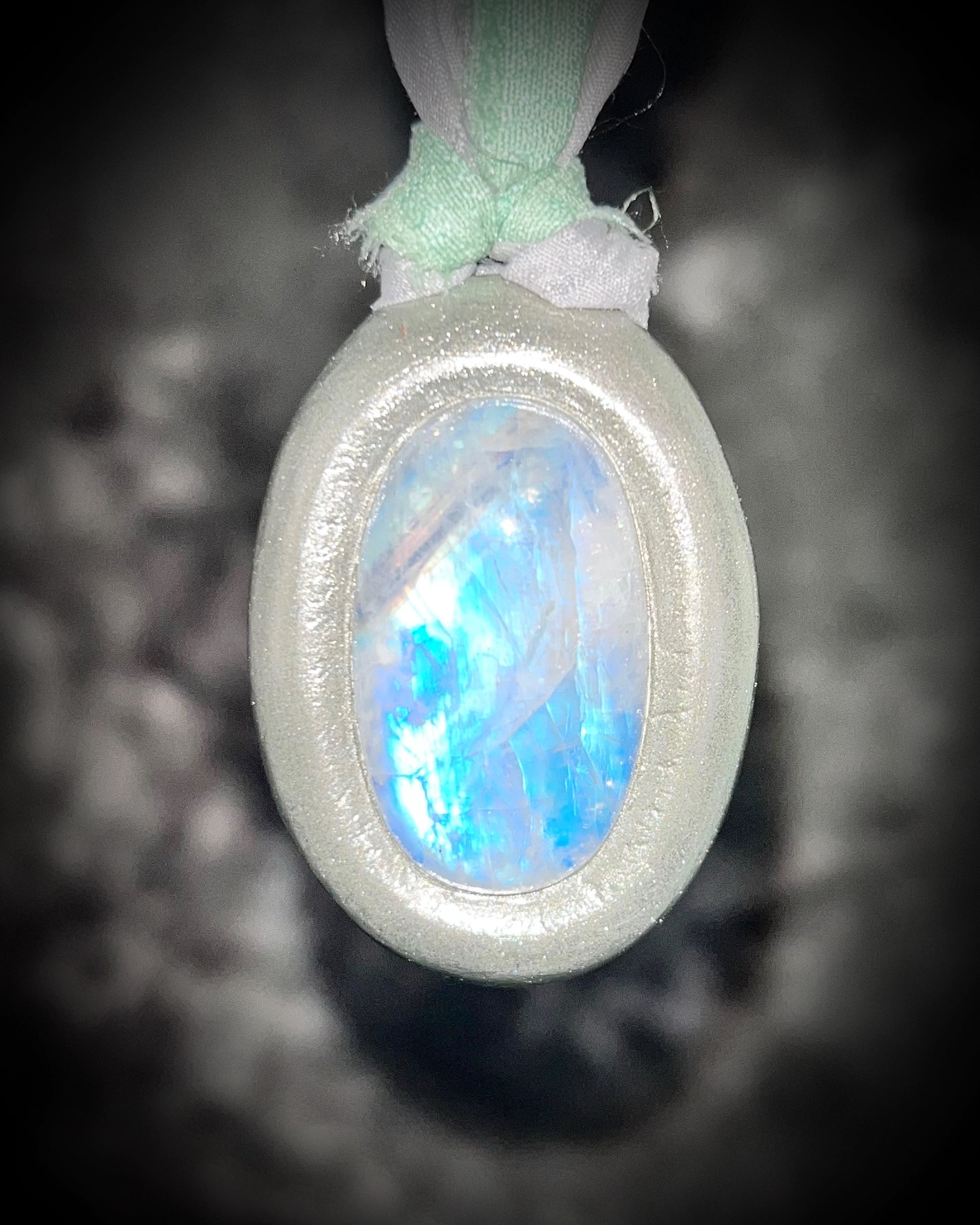 Mystical moonstone oval pendant in silver tone setting on recycled silk cord. Handmade crystal necklace for intuition, divine feminine energy, and spiritual connection. Unique gift for her, gemstone jewelry for meditation or daily wear.