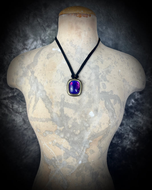 Necklace with a purple amethyst birthstone gemstone worn by a mannequin bust against a dark background.