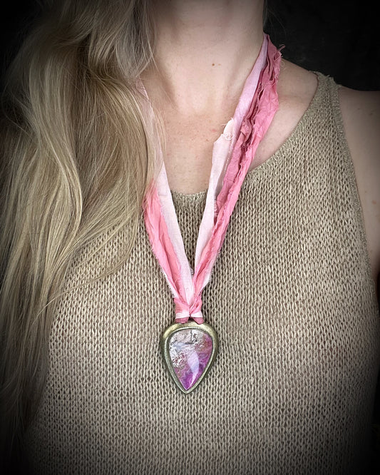 Pink calcite teardrop talisman with sculpted gold finish and ombre pink recycled silk ties. Handmade by Become Spellbound.
