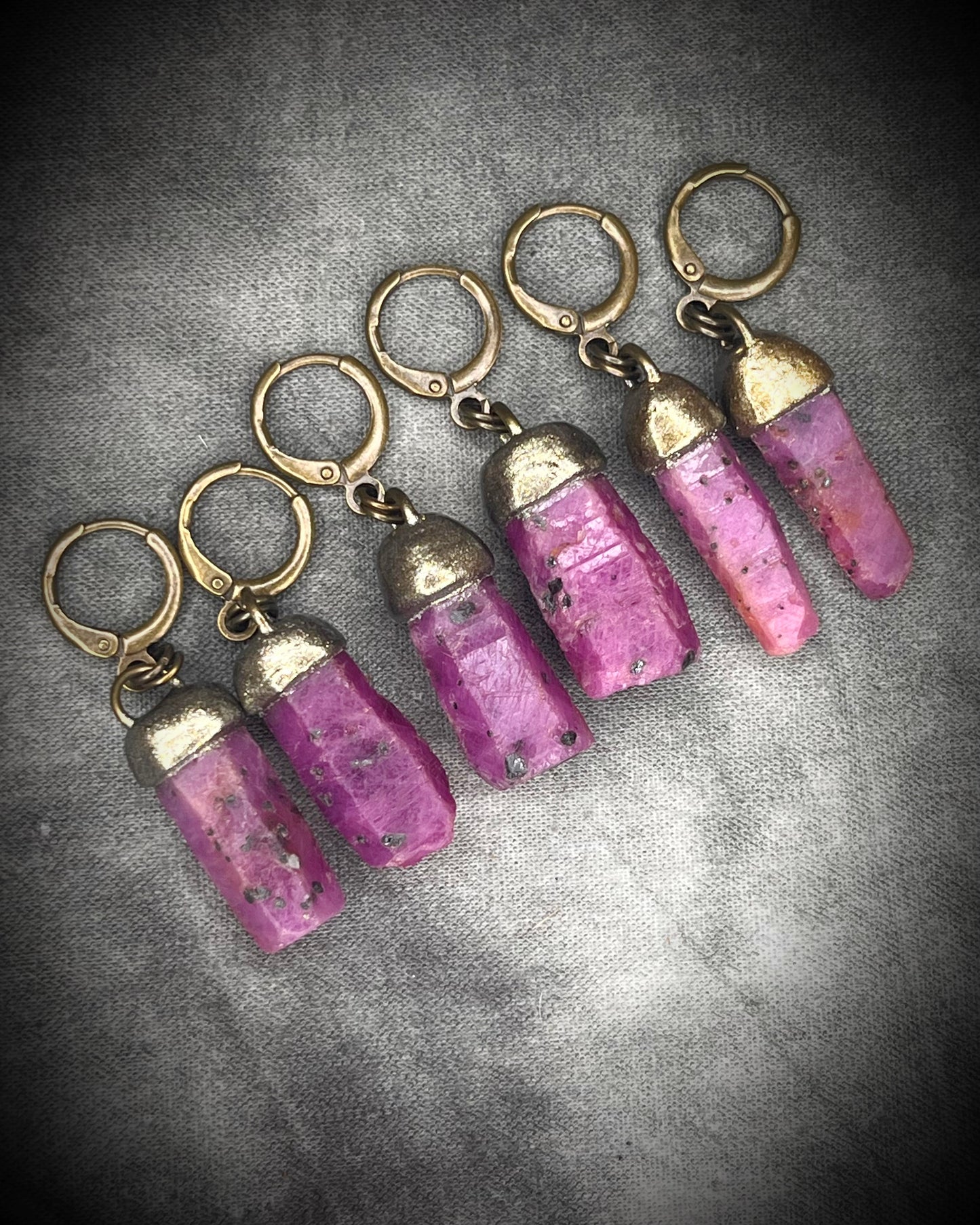 Raw ruby crystal earrings in gold finish on hypoallergenic brass huggie hooks, July birthstone gemstone jewelry handmade in Baltimore Maryland.