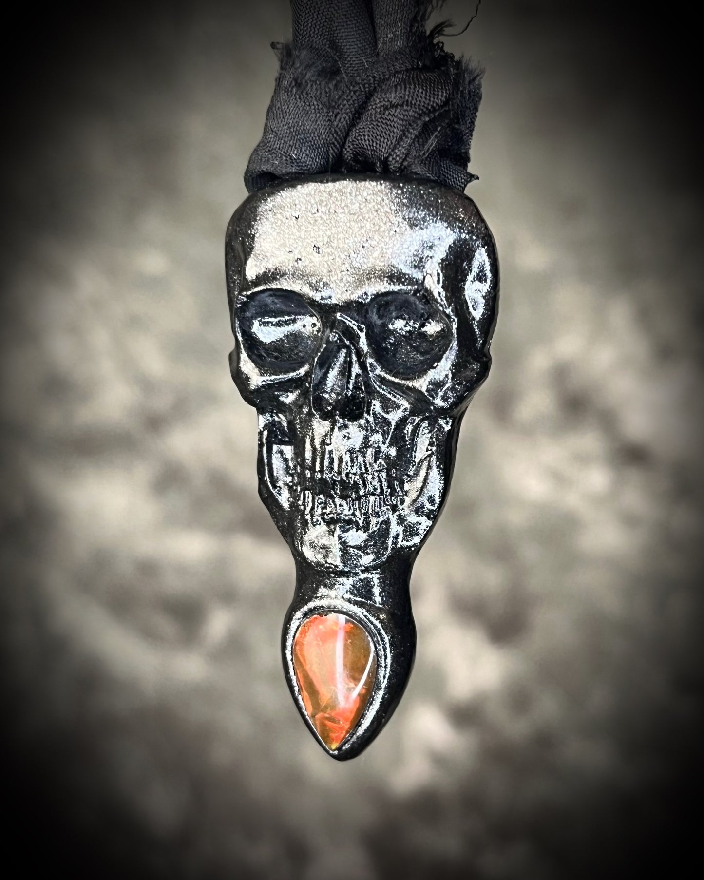 Black skull and red opalized ammolite gem necklace on black recycled silk. Macabre gothic jewelry for her, halloween gemstone jewelry for fall 2025 gift for him.