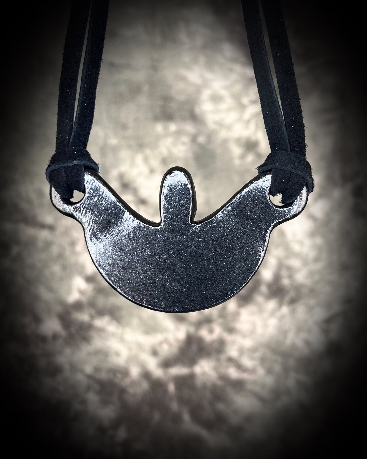 Silver Sheen obsidian crescent moon necklace with orange kyanite crystal. Dark luxury vibe gemstone necklace hung from black leather for a unisex goth look.