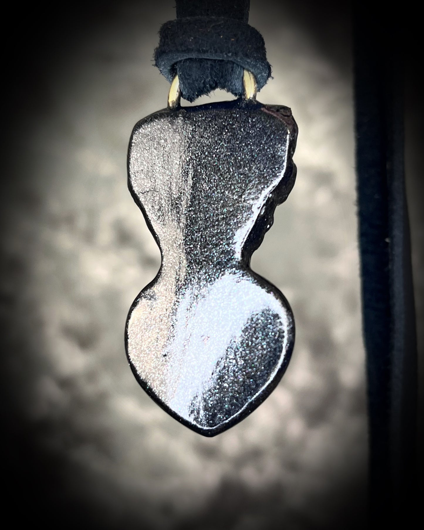 Skull-shaped pendant with a deep orange red carnelian heart shaped gemstone hung from black leather. Halloween jewelry for her, gothic jewelry gift for her.