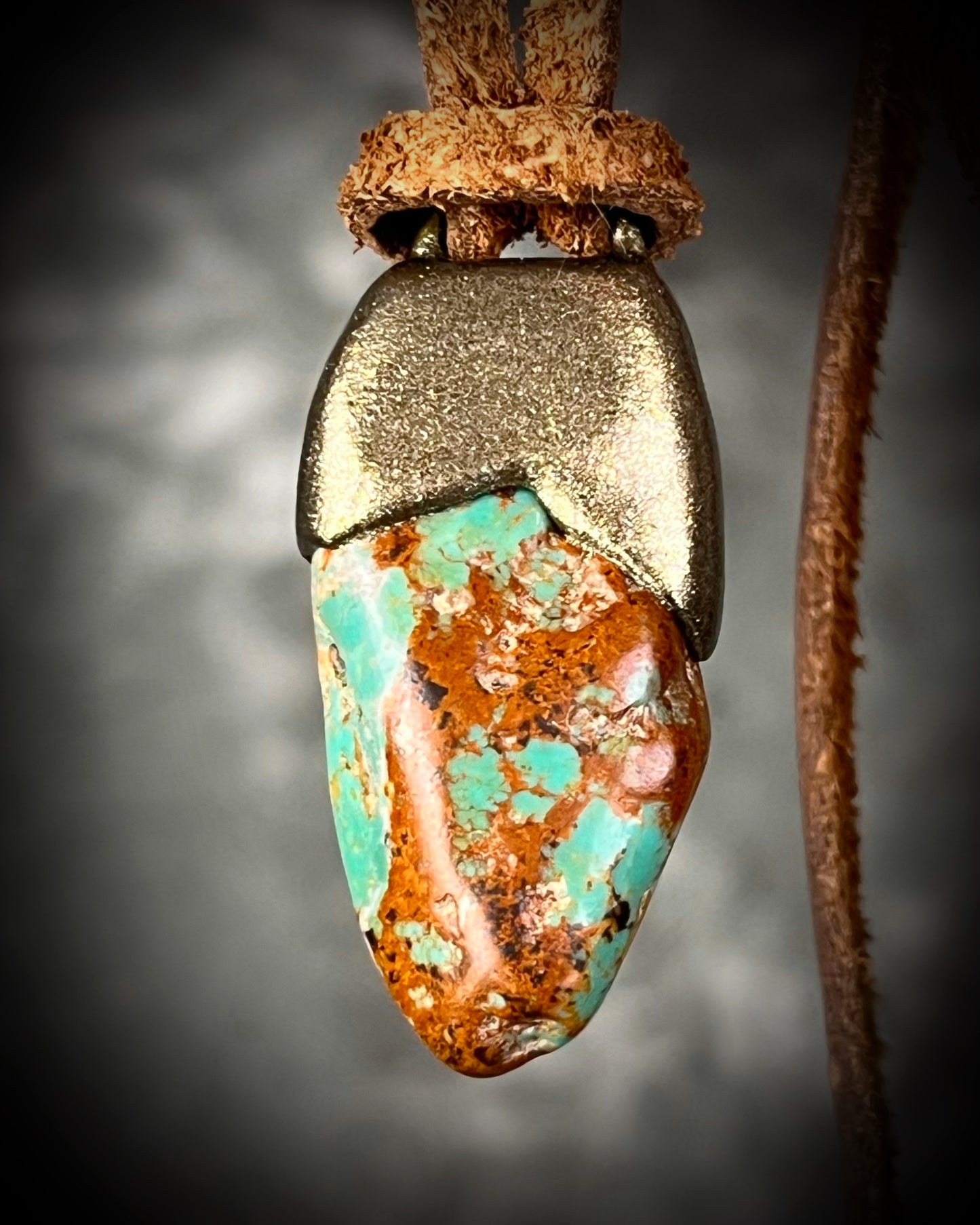 Turquoise stone pendant with brown veining in a gold setting hung on earthy brown leather. Western boho jewelry gift for her.