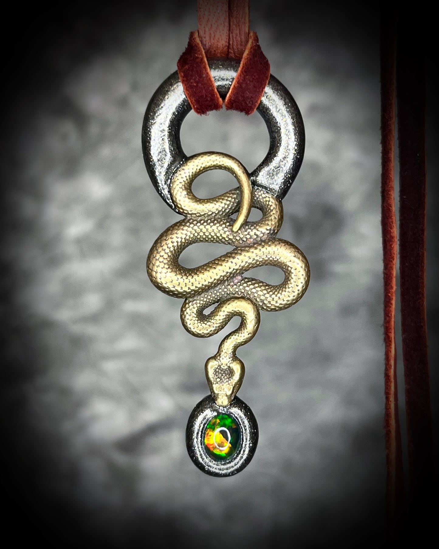 Witchy brass snake necklace with genuine black opal gemstone, spiritual talisman jewelry for empowerment, grounding, and mysticism.