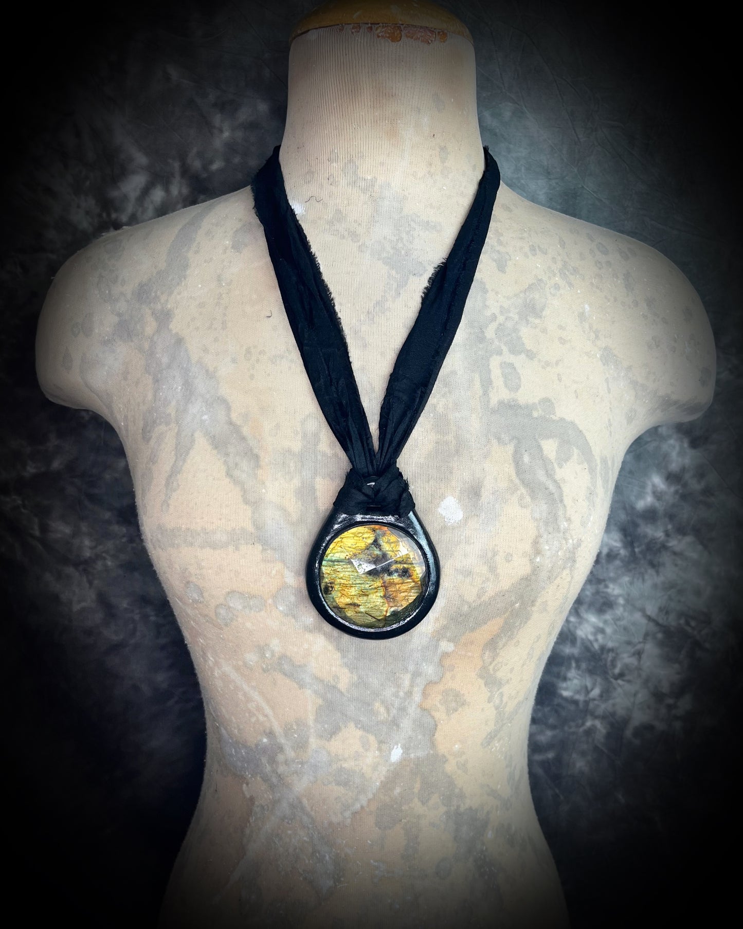 Witchy labradorite necklace on black recycled silk ribbon, hand-sculpted crystal talisman with iridescent gemstone pendant, boho gothic jewelry for modern witches.