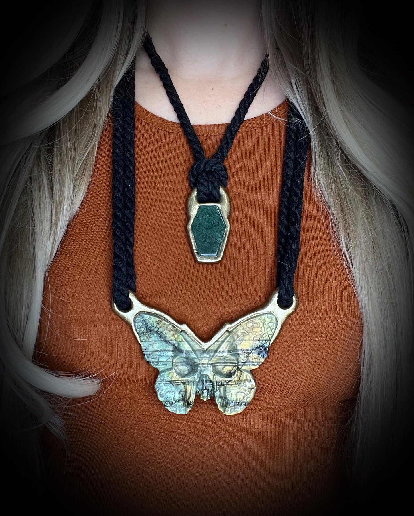 Moss agate coffin shaped necklace in a gold finish on a black cotton cord. Coffin crystal pendant fall 2025 gift for her.