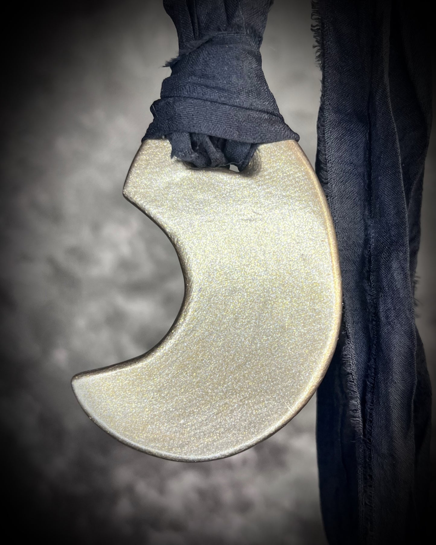 Metallic gold crescent moon pendant with iridescent rainbow quartz crystal on black recycled silk