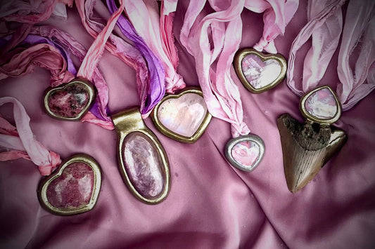 Valentines array of handmade pink crystal jewelry on soft pink recycled silks and in heart shapes.