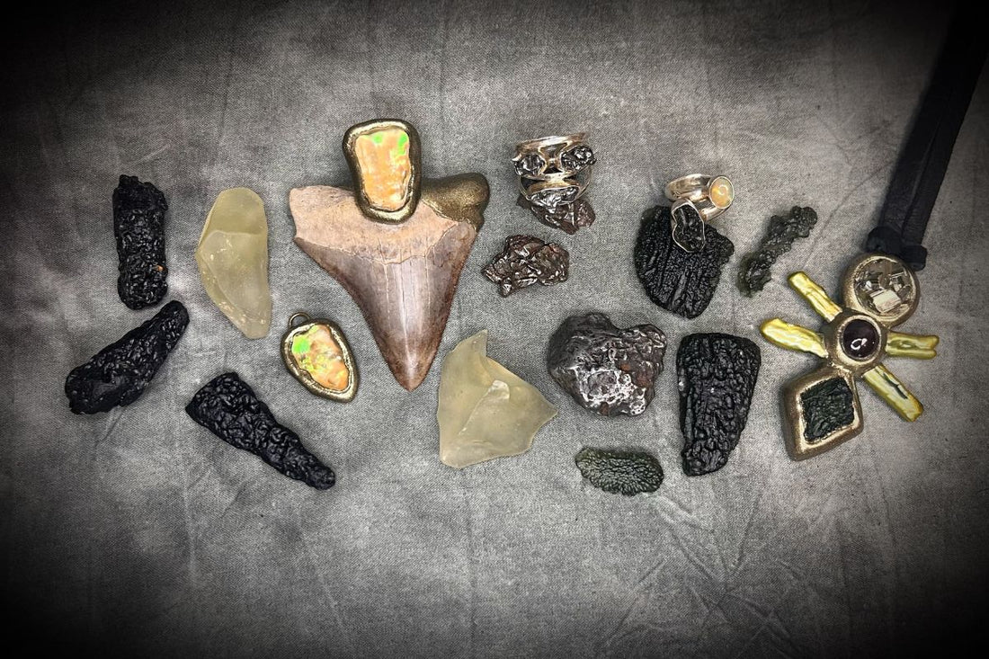 Blog Post by Become Spellbound. What Are Tektites? Moldavite, Libyan Desert Glass, and Other Impact Glasses Explained. Image features a couple tektites including moldavite, libyan desert glass and meteorites as well as some jewelry featuring them.