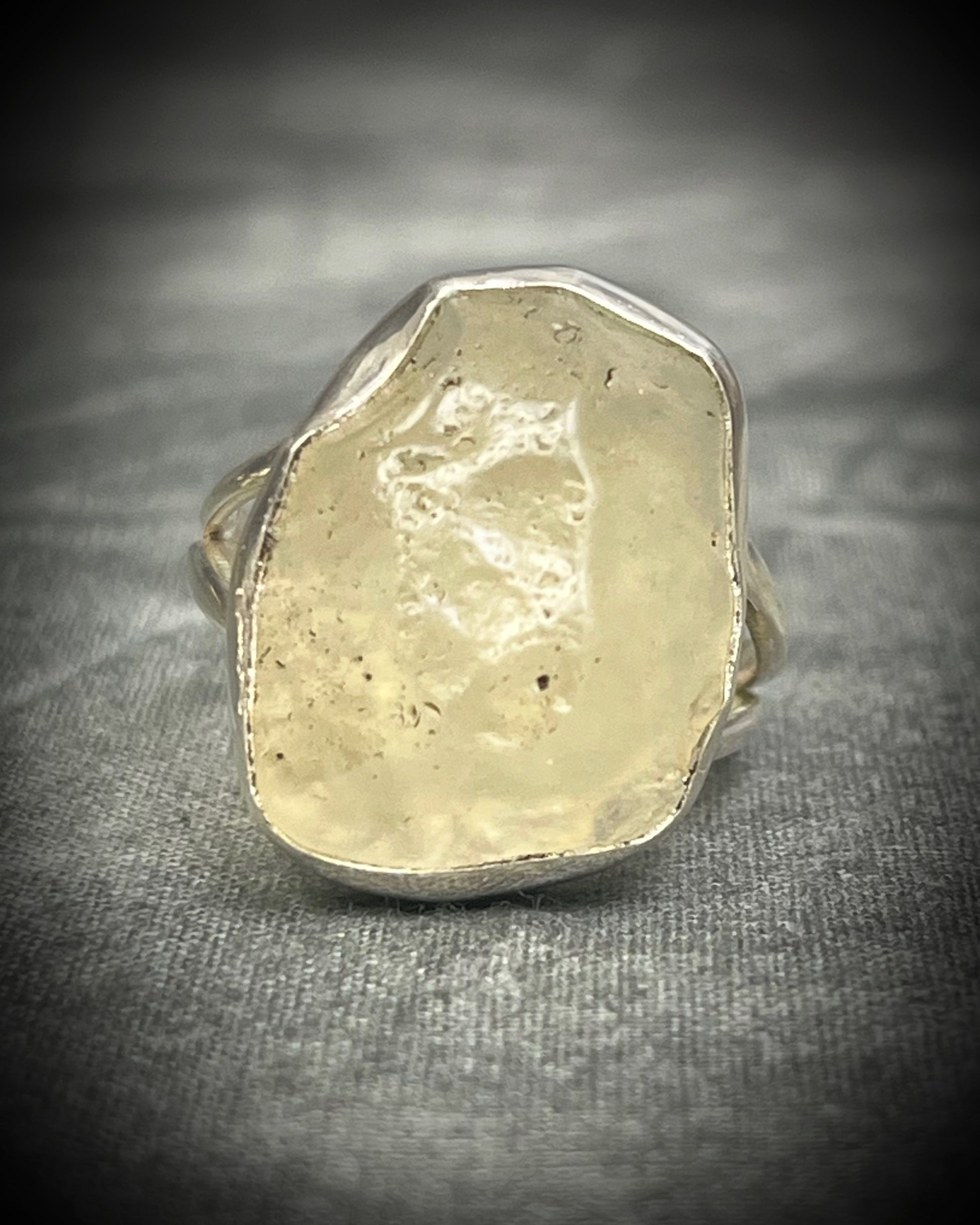Genuine Libyan Desert Glass sterling silver ring featuring ancient impact glass with luminous golden tones. One of a kind by Become Spellbound, Baltimore Magazine Best of Baltimore 2026 Jewelry winner.