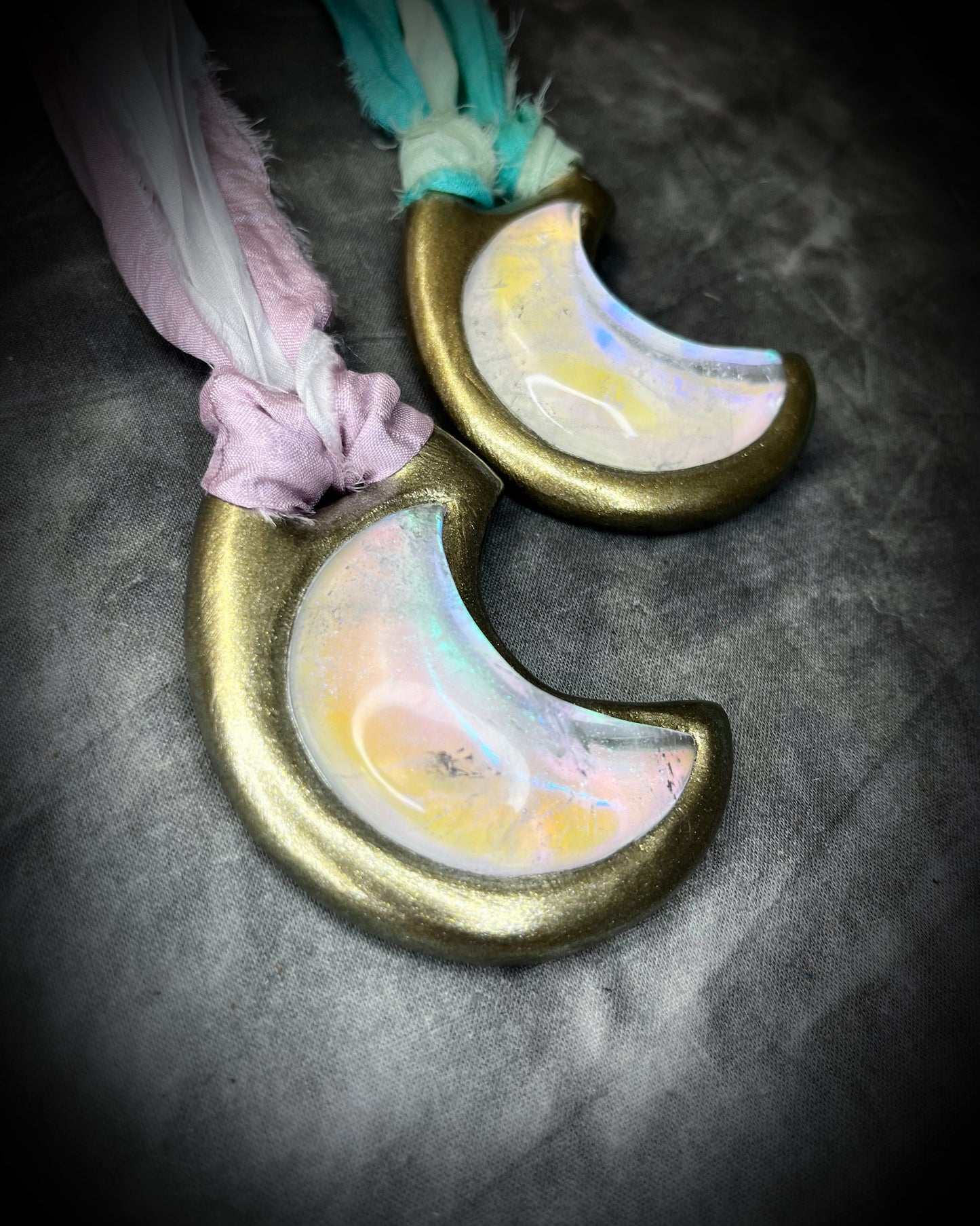 Handmade designer pink and green opalescent quartz gemstone crescent moon pendants in a gold finish.  These crystal healing necklaces are strung from lilac, white, turquoise and mint green recycled silk for the sustainable bride or jewelry collector.
