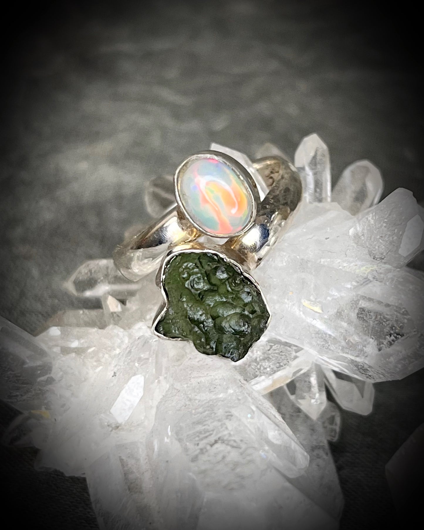 Raw stone adjustable statement rings in sterling silver featuring moldavite crystal and opal gemstone for spiritual elevation and crystal healing. 