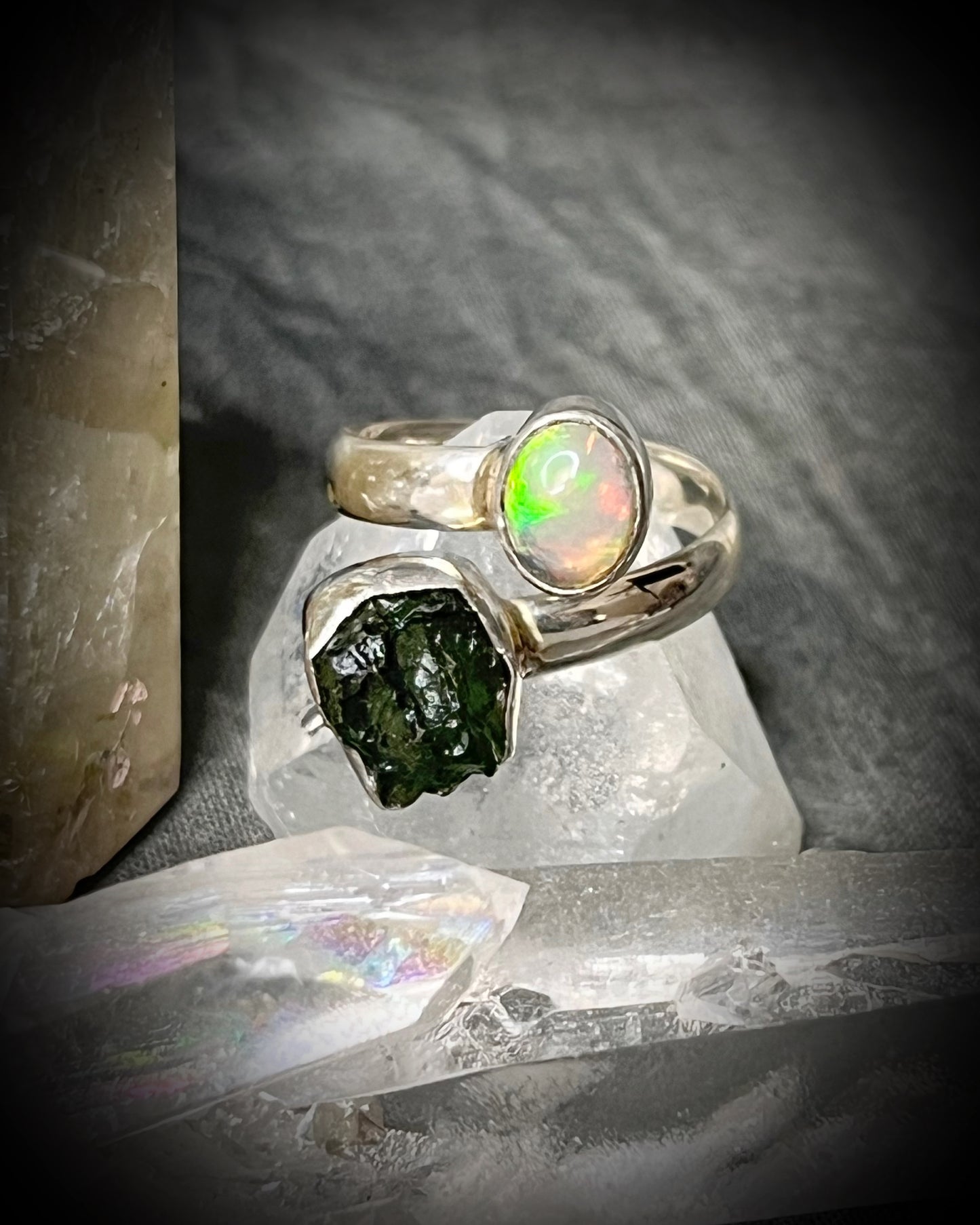 Raw stone adjustable statement rings in sterling silver featuring moldavite crystal and opal gemstone for spiritual elevation and crystal healing. 