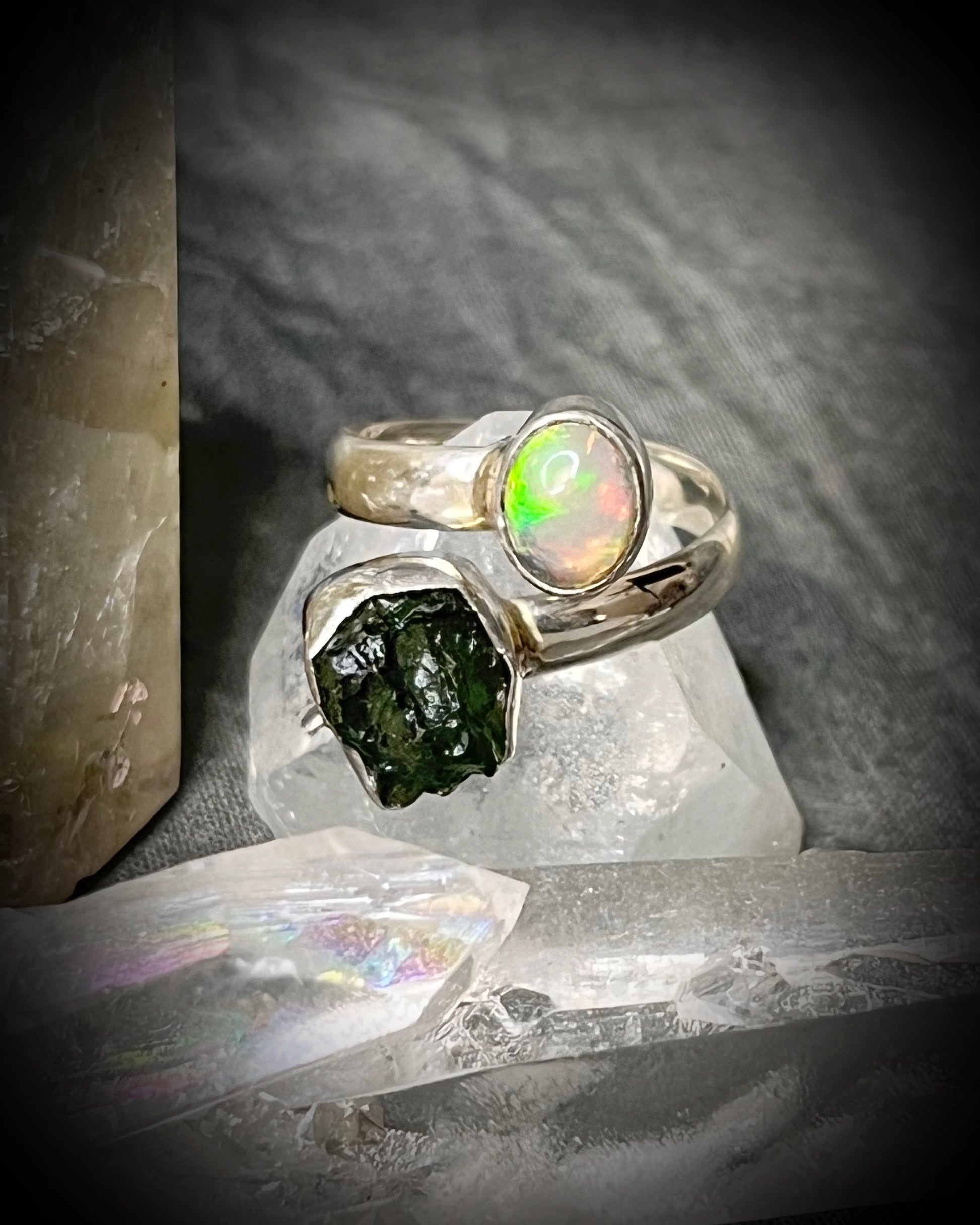 Raw stone adjustable statement rings in sterling silver featuring moldavite crystal and opal gemstone for spiritual elevation and crystal healing. 