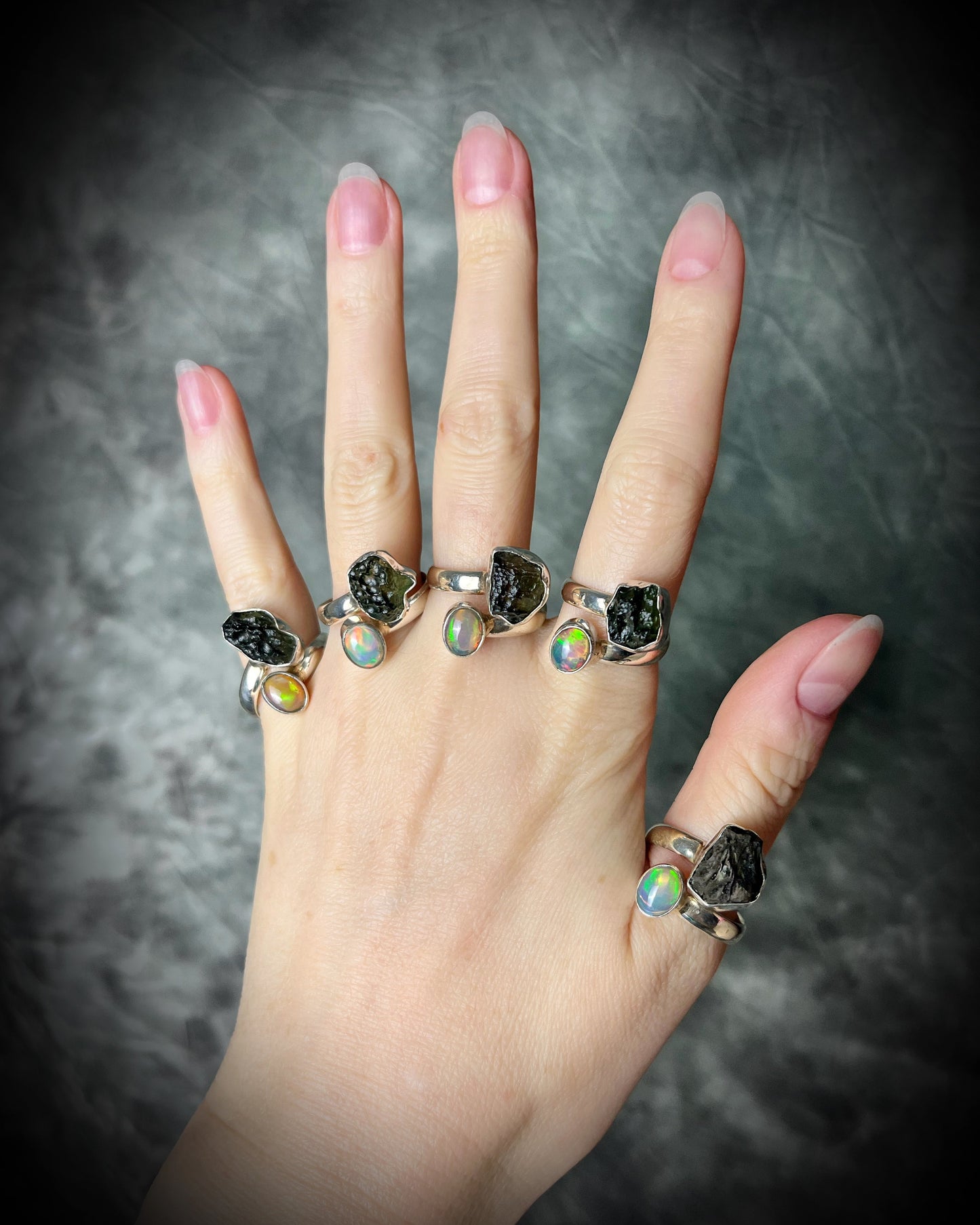 Raw stone adjustable statement rings in sterling silver featuring moldavite crystal and opal gemstone for spiritual elevation and crystal healing. 