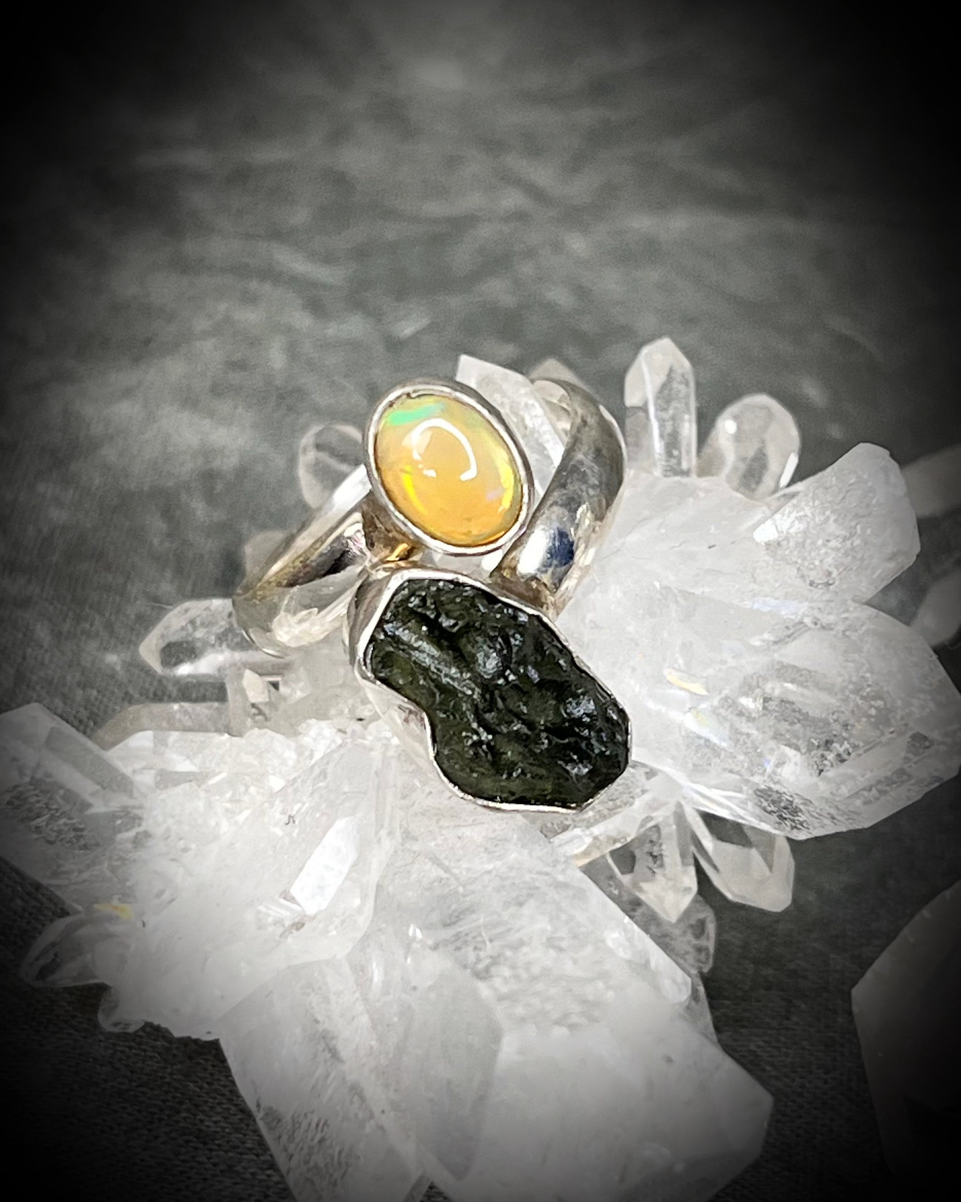 Raw stone adjustable statement rings in sterling silver featuring moldavite crystal and opal gemstone for spiritual elevation and crystal healing. 