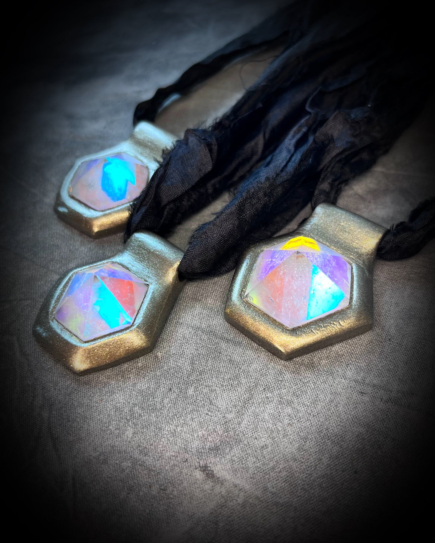 Handmade designer clear opalescent quartz gemstone pendants in a gold finish.  These vintage inspired crystal healing pyramid hexagon necklaces are strung from black recycled silk for the sustainable and eco-friendly jewelry lover, boho babe or modern mystic. 