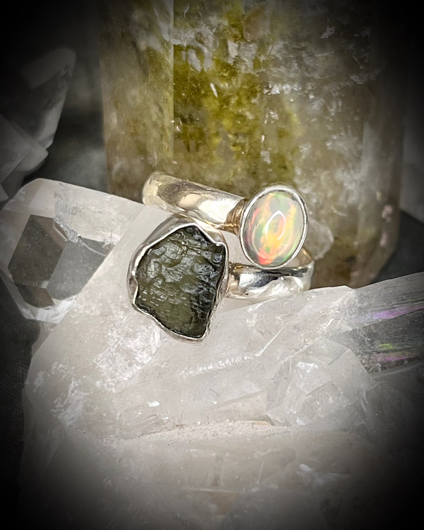 Raw stone adjustable statement rings in sterling silver featuring moldavite crystal and opal gemstone for spiritual elevation and crystal healing. 
