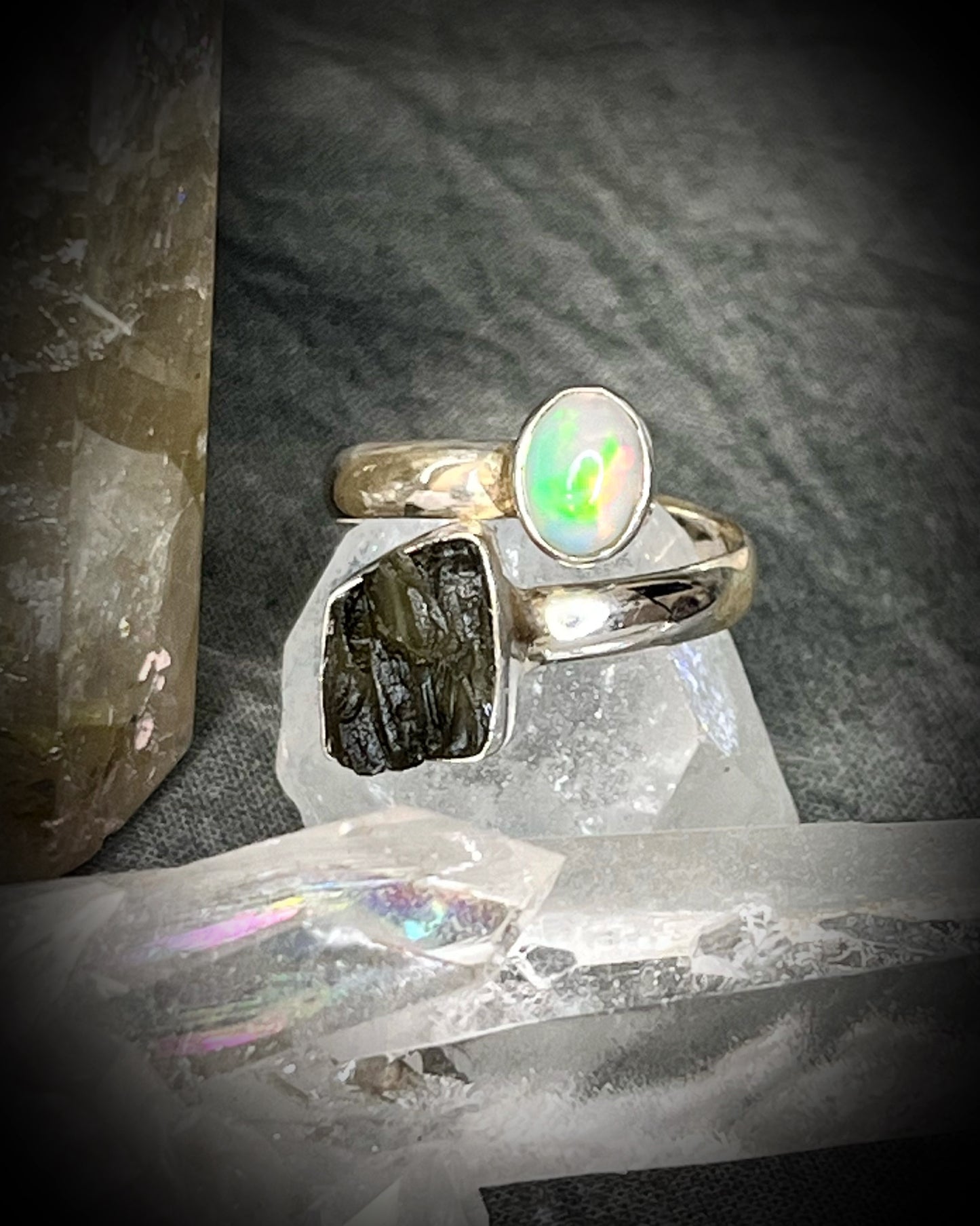 Raw stone adjustable statement rings in sterling silver featuring moldavite crystal and opal gemstone for spiritual elevation and crystal healing. 