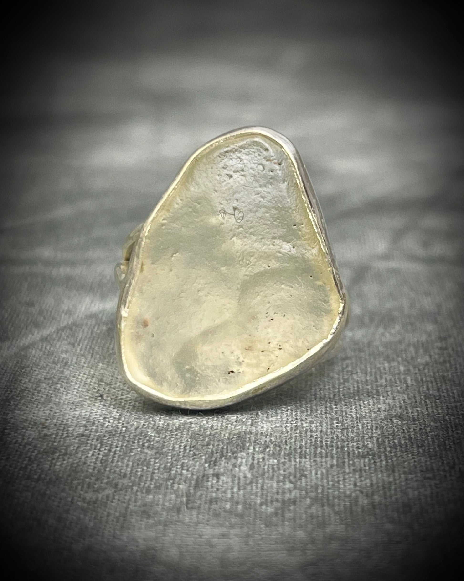 Genuine Libyan Desert Glass sterling silver ring featuring ancient impact glass with luminous golden tones. One of a kind by Become Spellbound, Baltimore Magazine Best of Baltimore 2026 Jewelry winner.