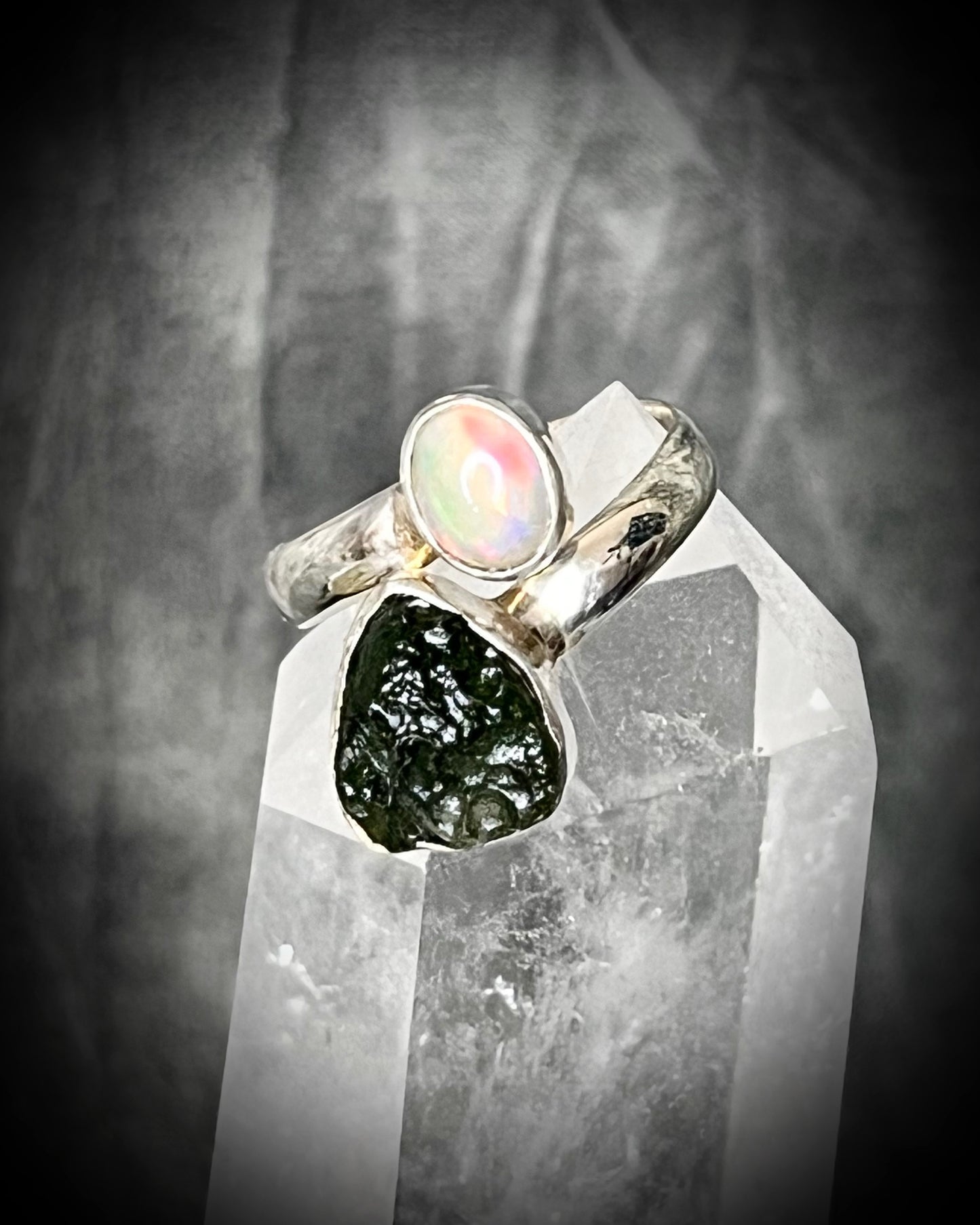 Raw stone adjustable statement rings in sterling silver featuring moldavite crystal and opal gemstone for spiritual elevation and crystal healing. 